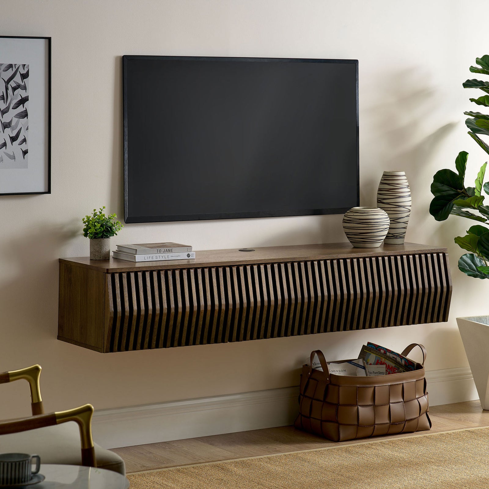 Walnut floating TV console installed beneath a wall-mounted screen in a cozy living room || EEI-7164-WAL || front_angle_room
