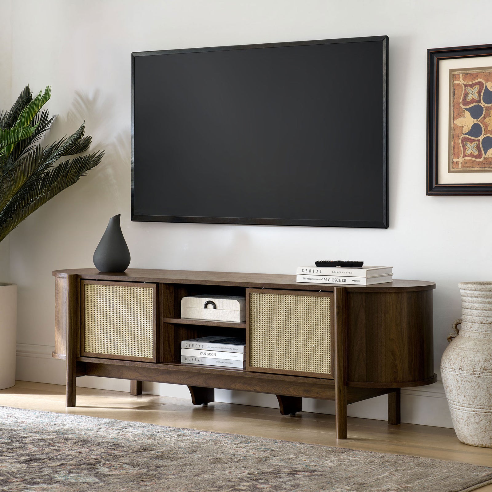 Walnut TV console styled in a living room with mounted screen and curated decor accents || EEI-7165-WAL || front_angle_room