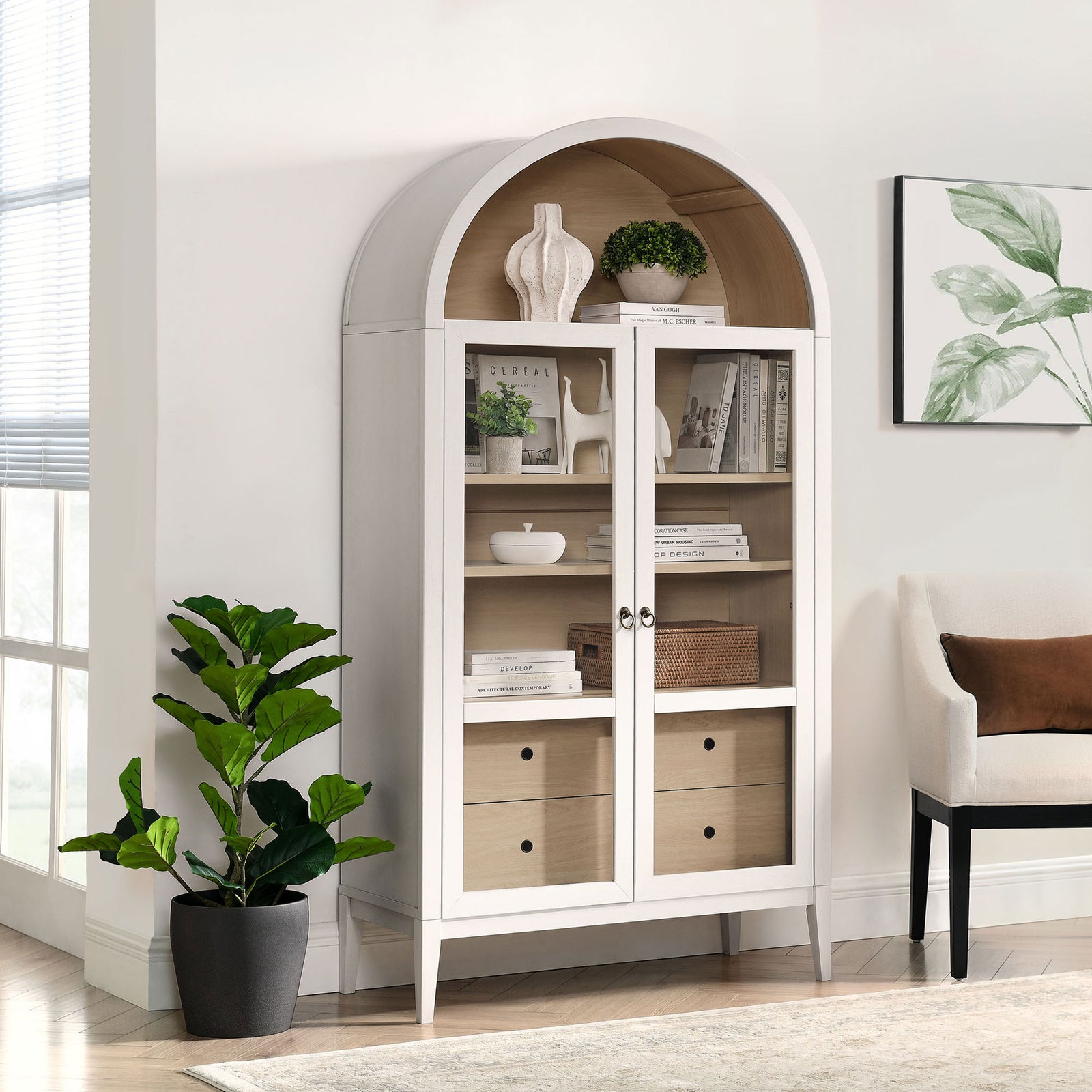 Ivory oak arched cabinet styled with greenery, ceramics, and books in a bright living room || EEI-7168-IVO-OAK || front_angle_room