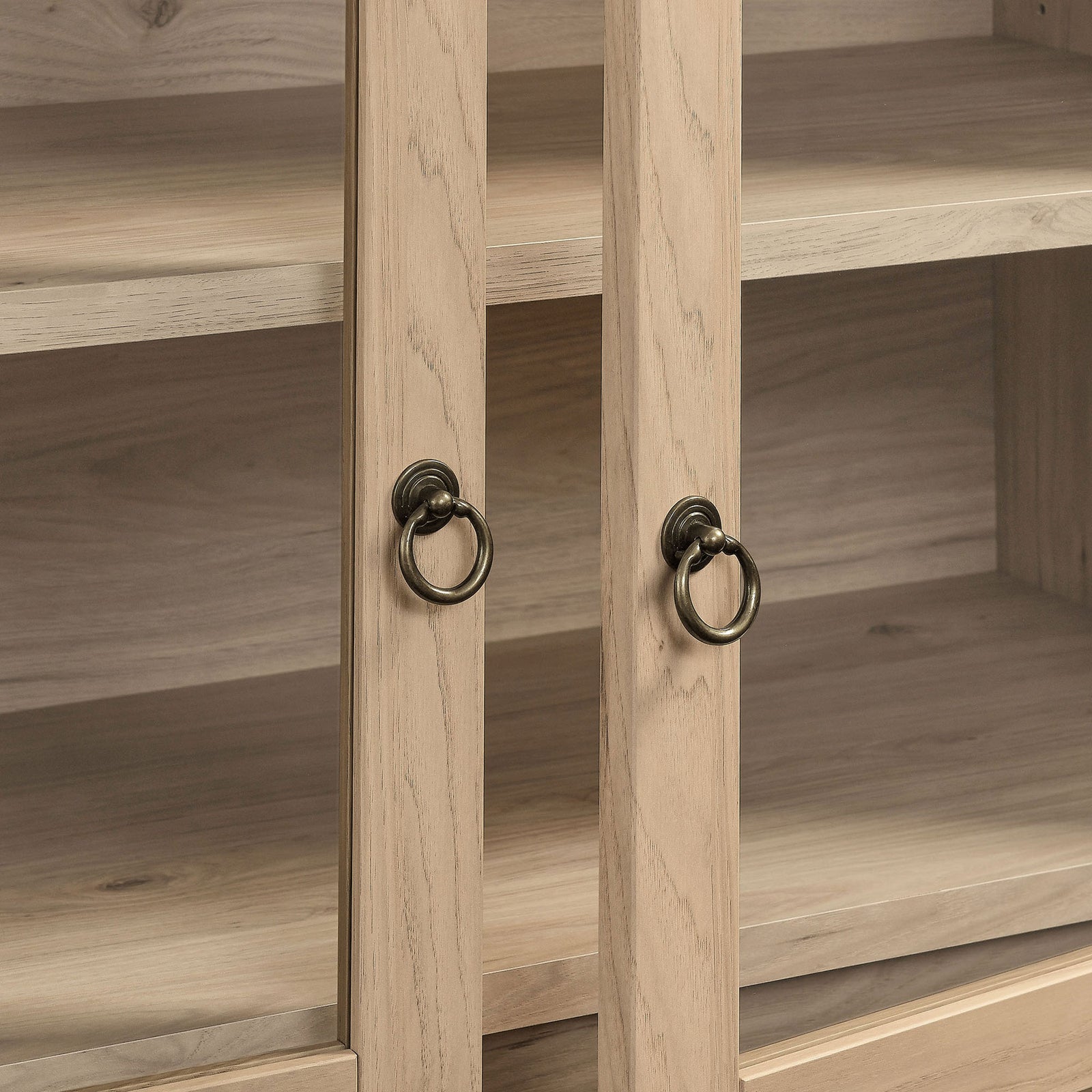 Warm brass ring pulls accent the light oak frame and clear glass doors || EEI-7168-LOA || handle_studio