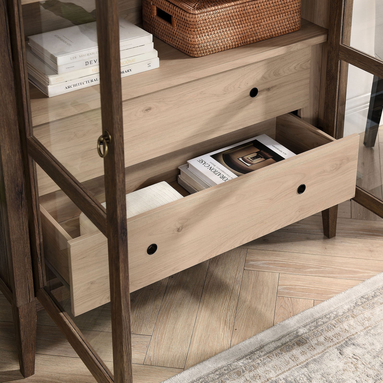 Lower drawer of the walnut and light oak cabinet storing books, textiles, and everyday accents || EEI-7168-WAL-LOA || storage_open_room