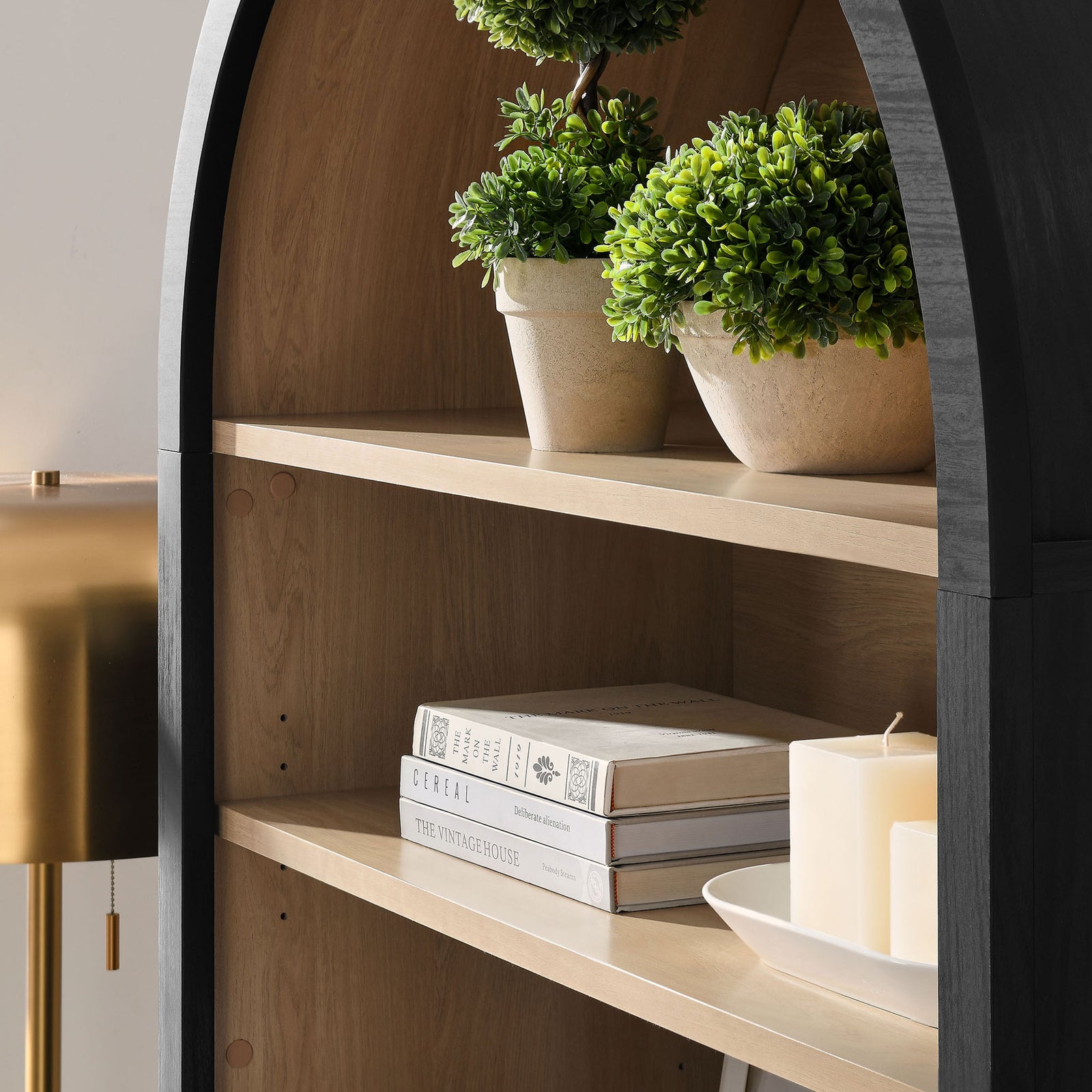 Warm wood-grain shelving displays decor beautifully within the arched nook || EEI-7169-BLK-OAK || detail_room
