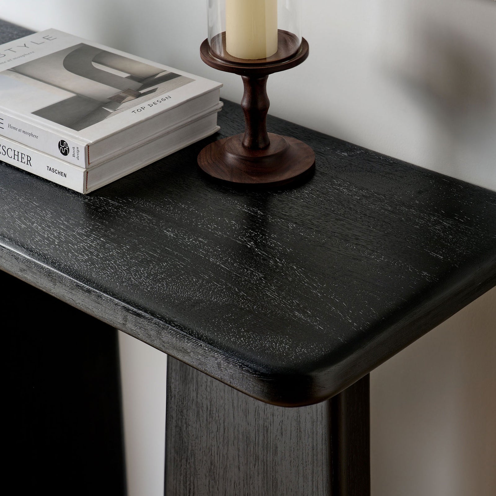 Styled tabletop scene highlighting the console's smooth finish and softly curved edges || EEI-7197-BLK || detail_room