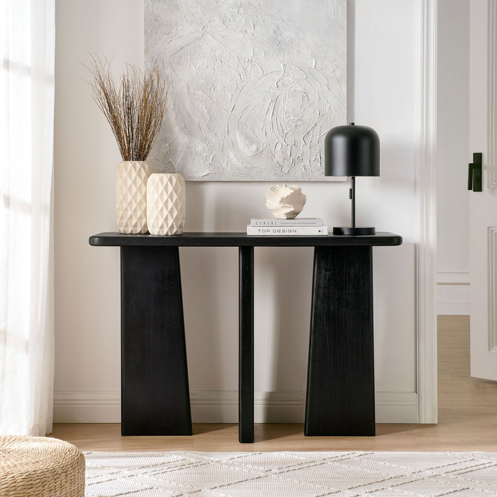 Elegant console with bold geometric legs and a sleek black finish for modern spaces || EEI-7197-BLK || front_room