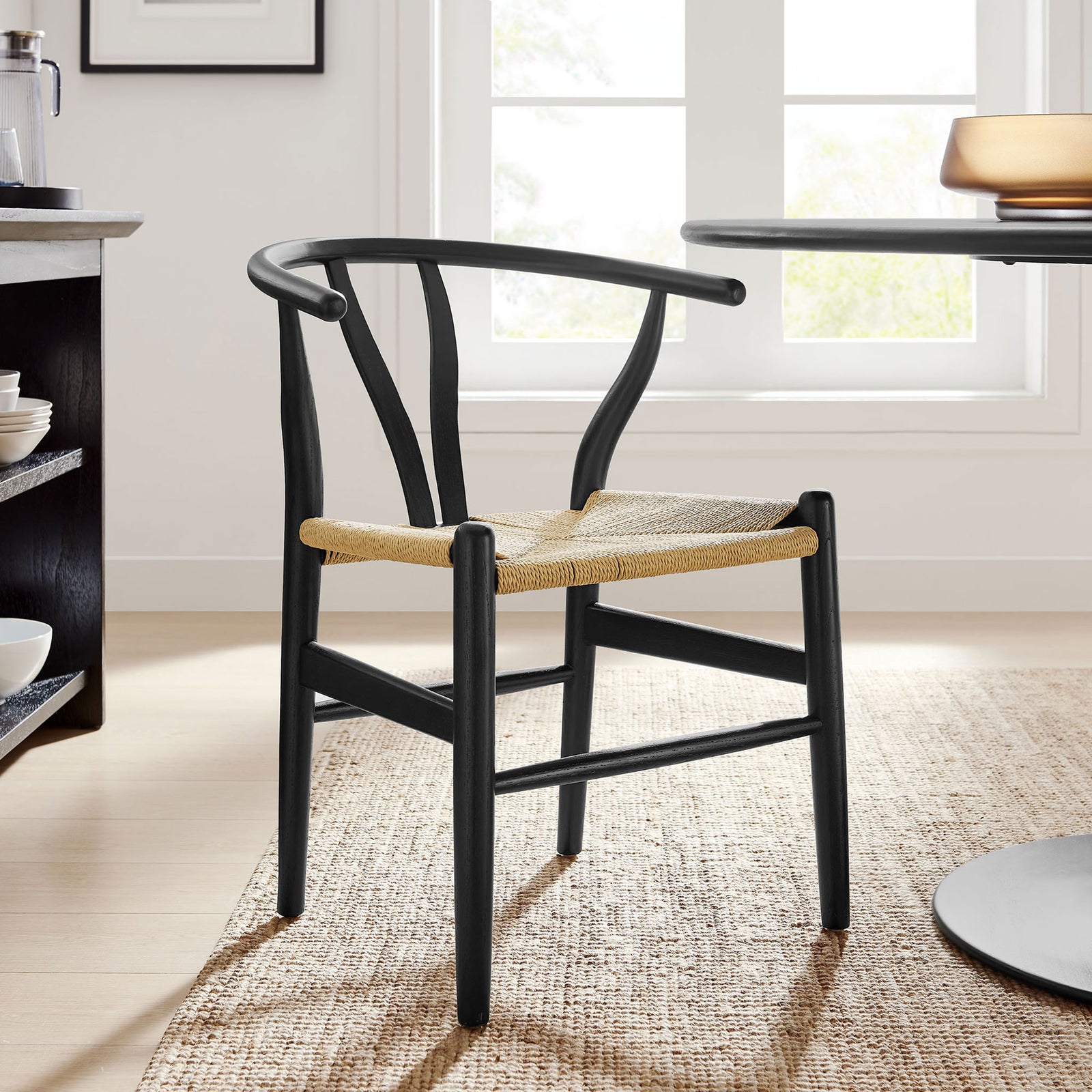 Black wood and rope dining chair anchors a bright, airy breakfast nook with effortless mid-century charm || EEI-7200-BLK || front_angle_room