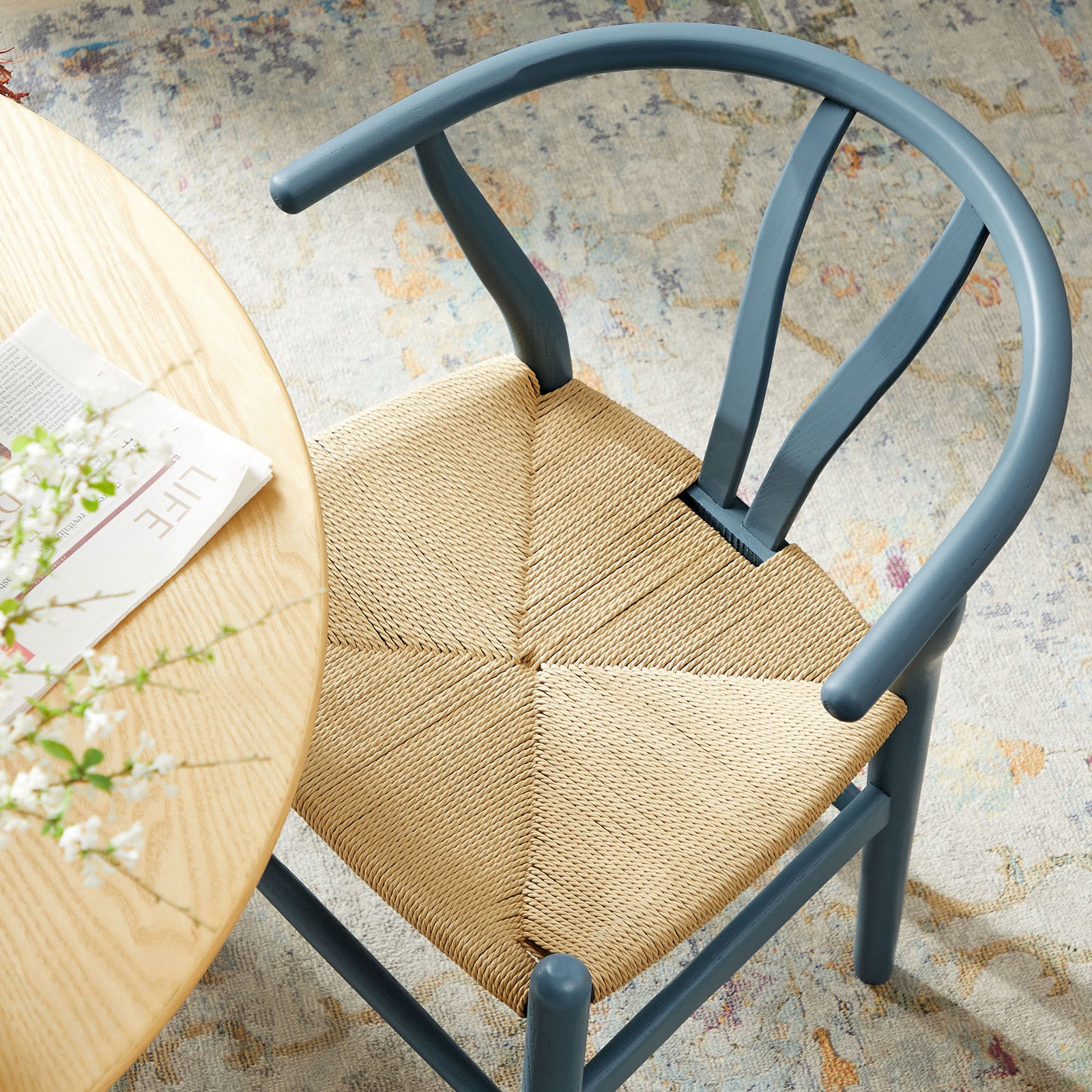 Harbor blue rope seat dining chair paired with round wood table over patterned rug || EEI-7200-HAR || detail_room