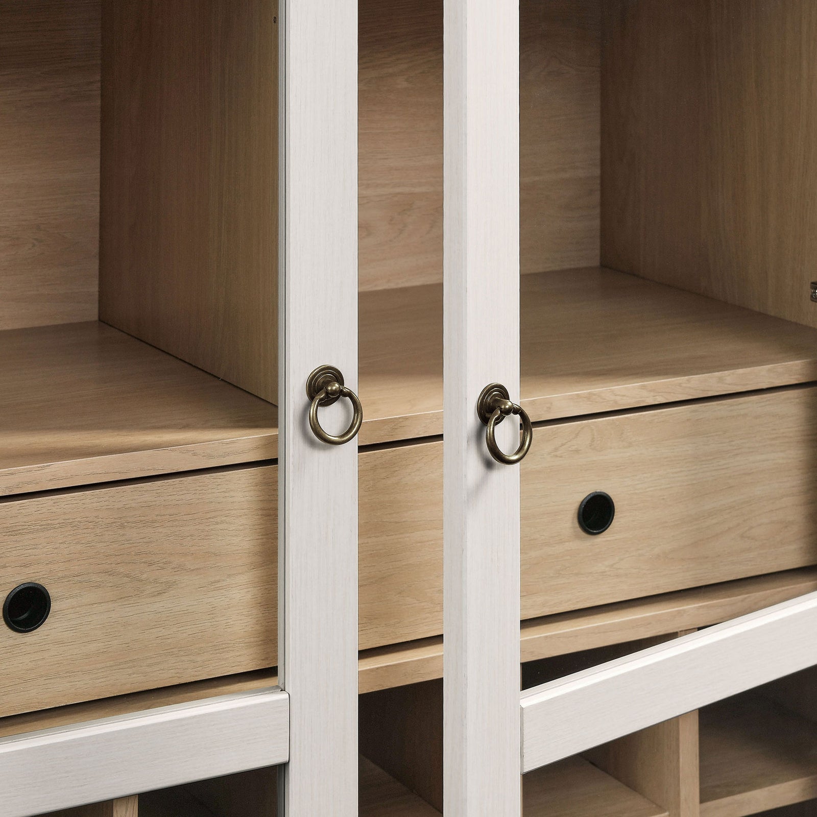 Brushed gold metal ring pulls lend elegant detail to the glass-front cabinet || EEI-7203-IVO-OAK || handle_studio
