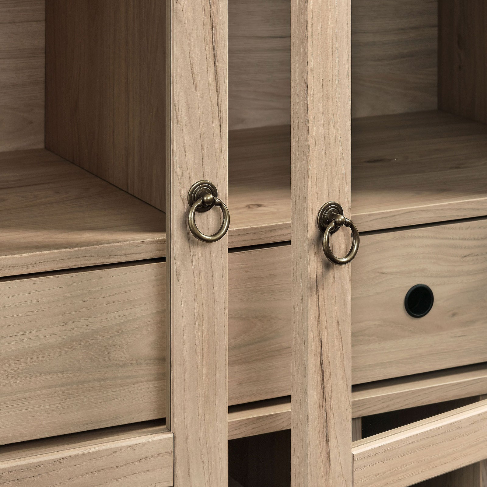 Brushed gold ring pulls accent the glass-front doors with a refined, timeless touch. || EEI-7203-LOA || handle_studio