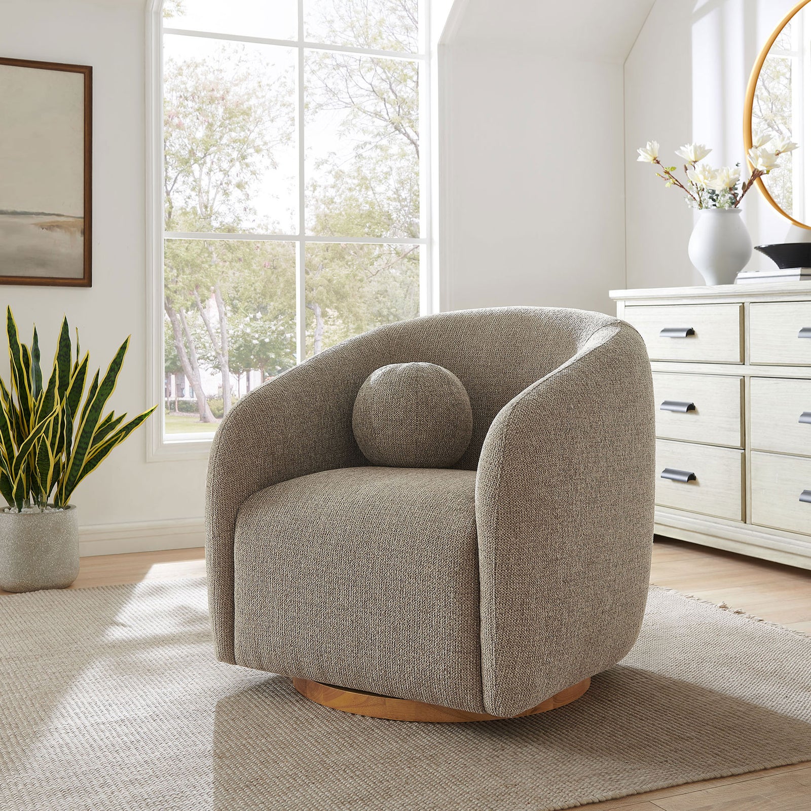 Modern swivel armchair elevates the room with its rounded silhouette and cozy ball pillow || EEI-7218-TAU || front_angle_room