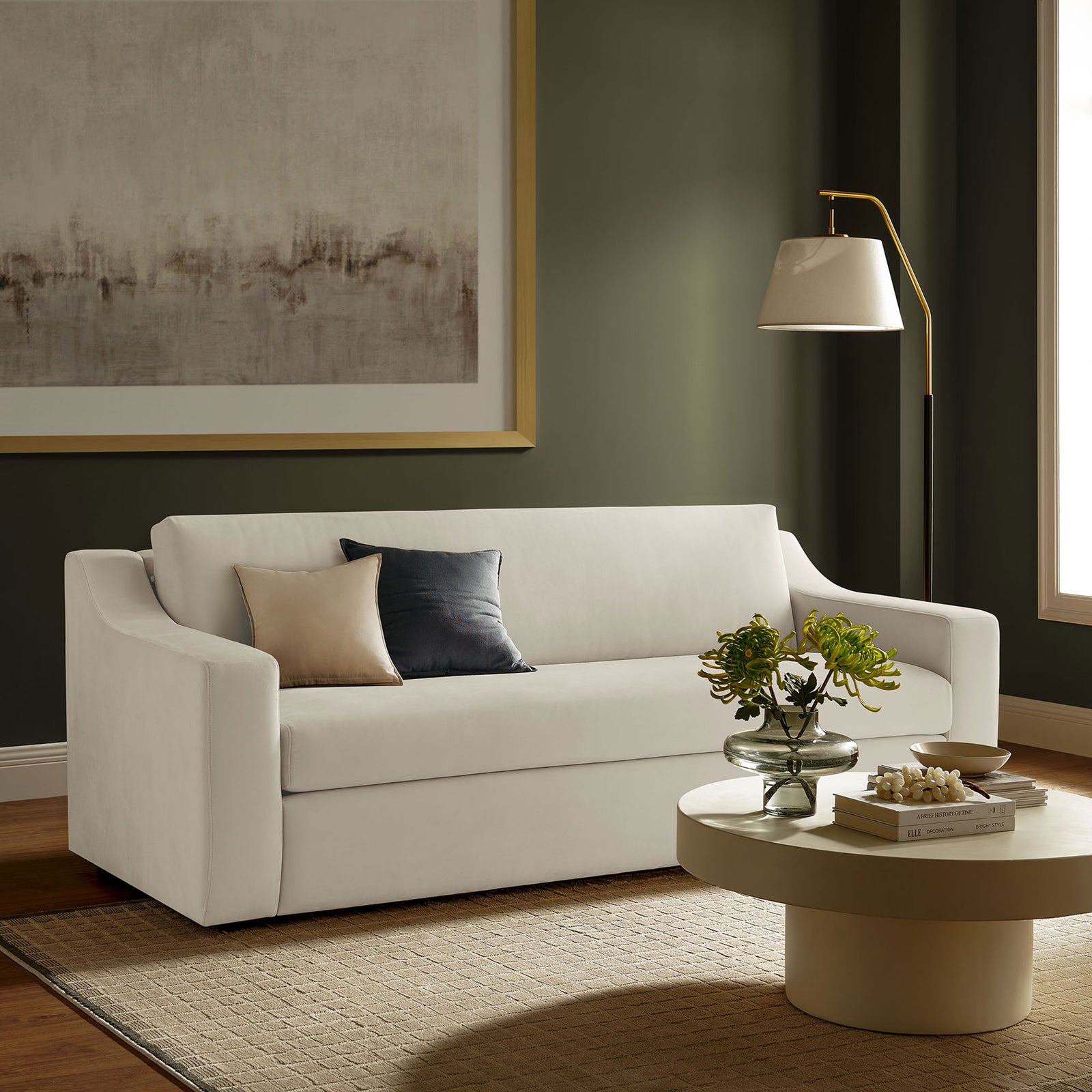 Alabaster velvet sofa anchors a contemporary living room with layered pillows, modern lamp, and round coffee table || EEI-7219-ALA || front_angle_room
