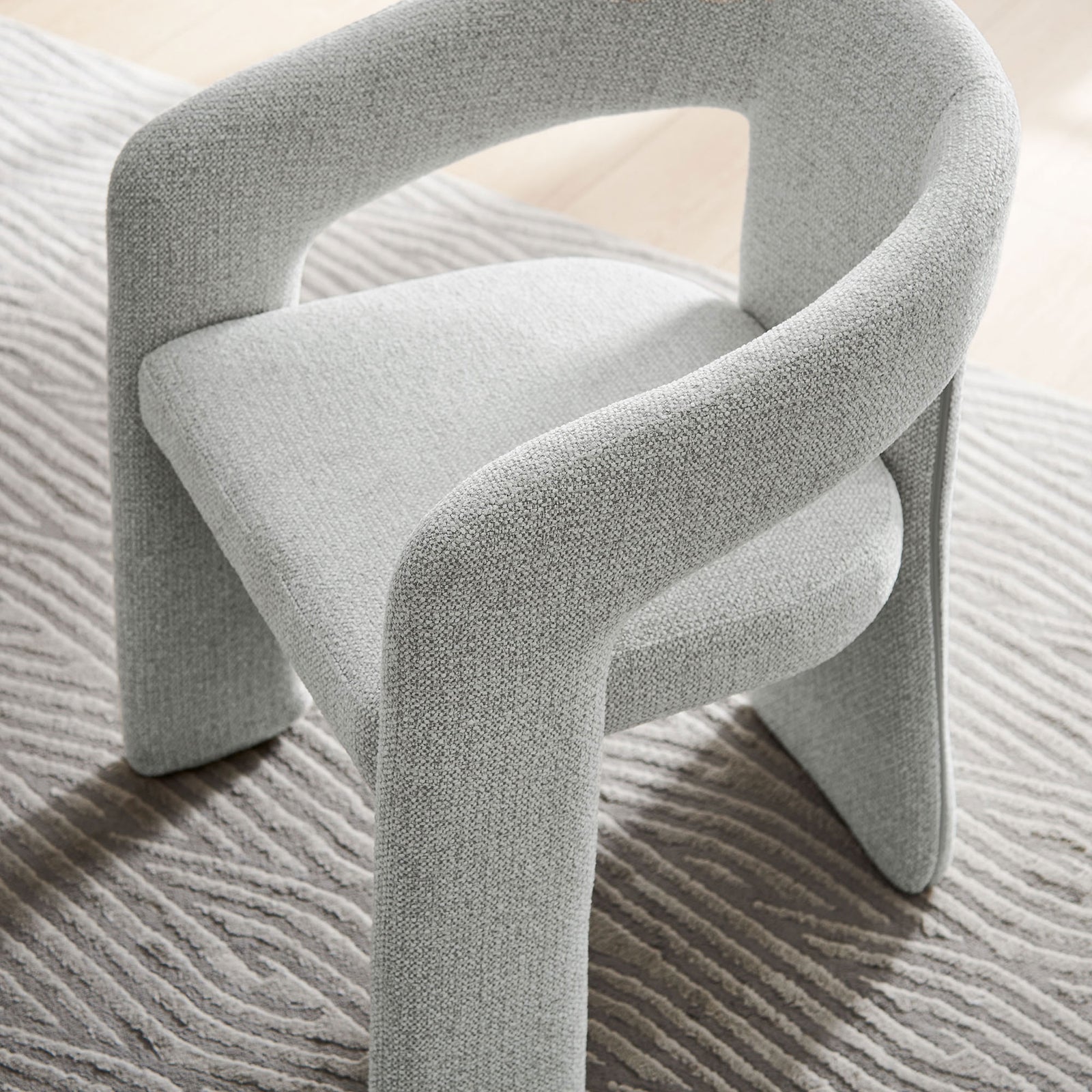 Oslo barrel dining chair in dove gray styled on a patterned rug for a modern cozy look || EEI-7224-DOV || front_angle_room