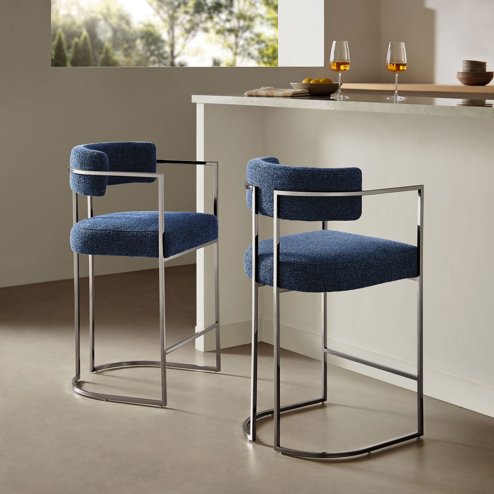 Modern counter stool elevates a kitchen island with plush navy seat and airy chrome base || EEI-7227-SLV-NAV || front_angle_room