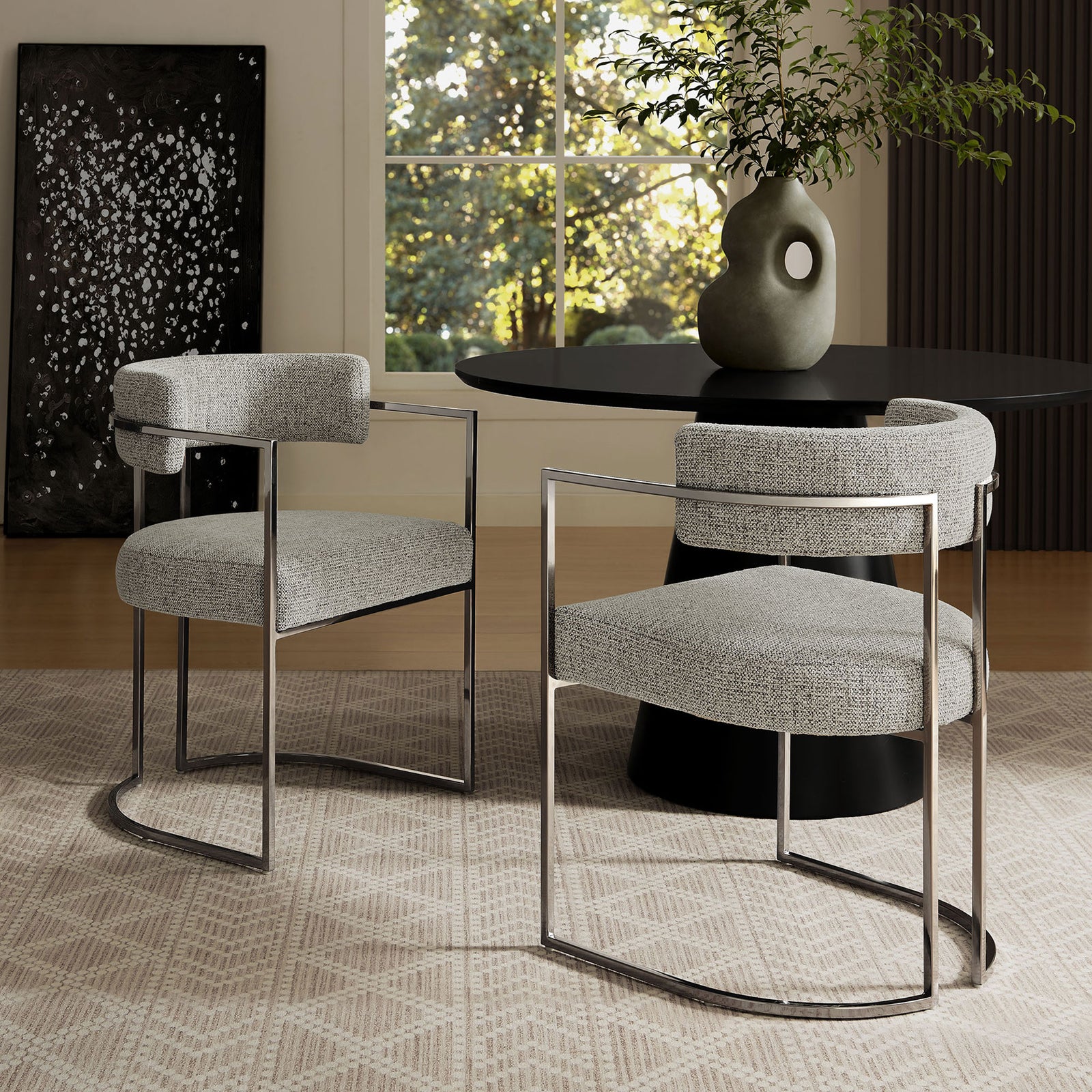 Pair of Silver Wheat barrel-back chairs grouped around a modern black pedestal dining table || EEI-7228-SLV-WHE || front_angle_room