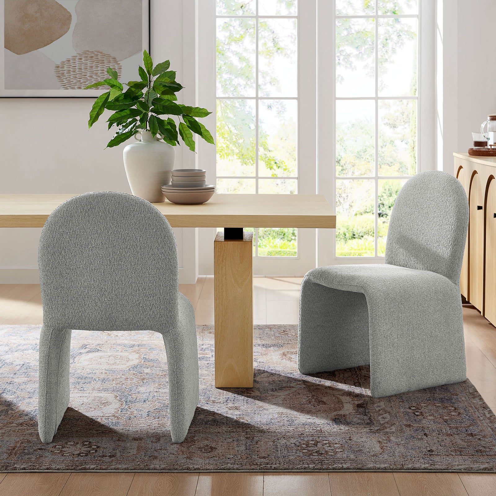 Pair of dove gray boucle dining chairs styled around a modern light wood dining table || EEI-7231-DOV || front_angle_room