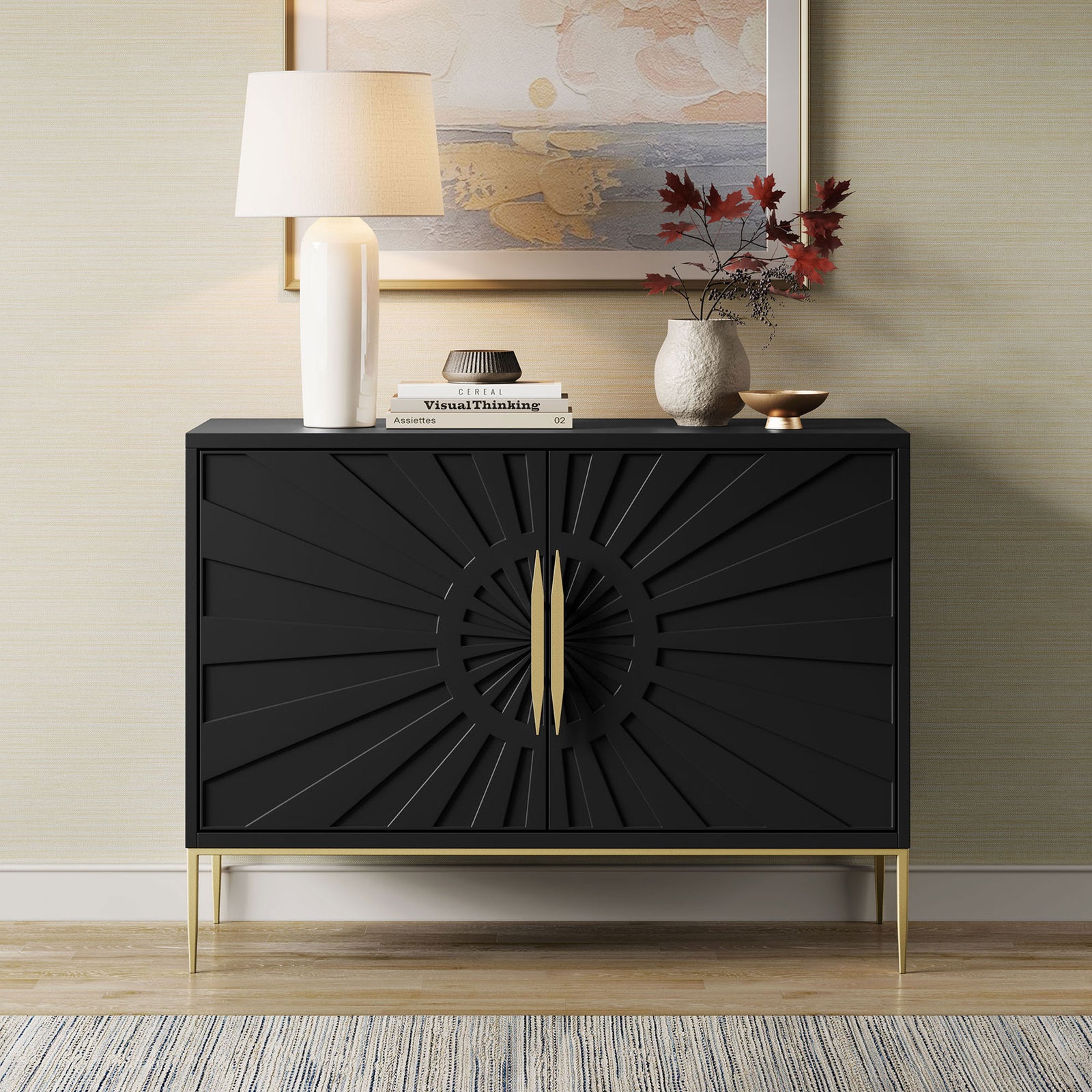 Wide black sunburst accent cabinet with gold base styled in a living room with art and accessories. || EEI-7234-BLK || front_angle_room