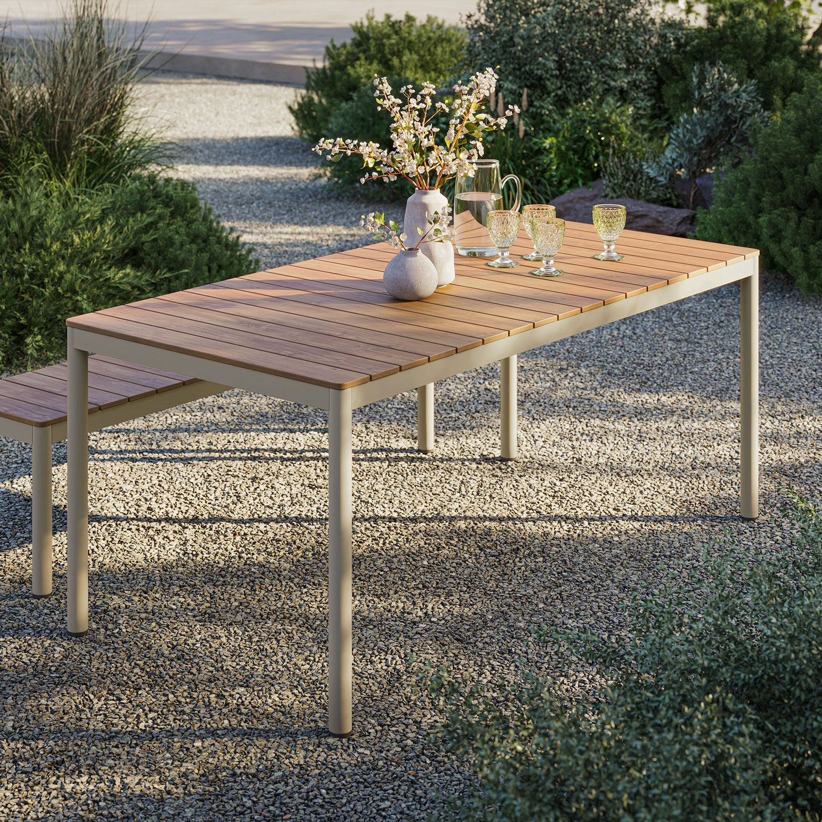 Finn outdoor dining table in a garden setting with natural slatted top and cream frame arranged for entertaining || EEI-7237-NAT || front_angle_room