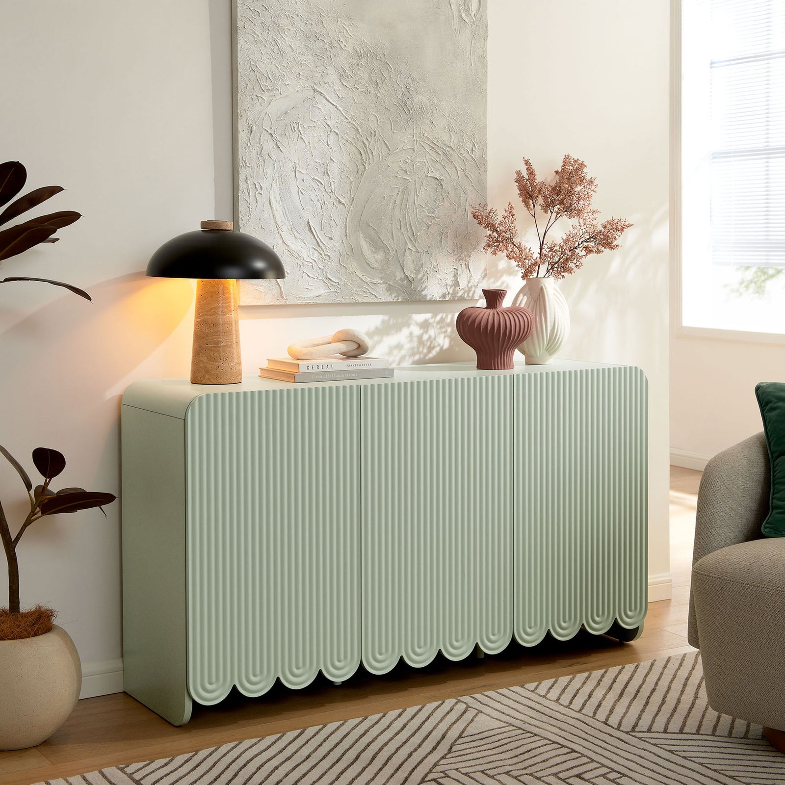 Dahlia sage green sideboard styled in a modern living room with decor and soft natural light || EEI-7241-SGE || front_angle_room