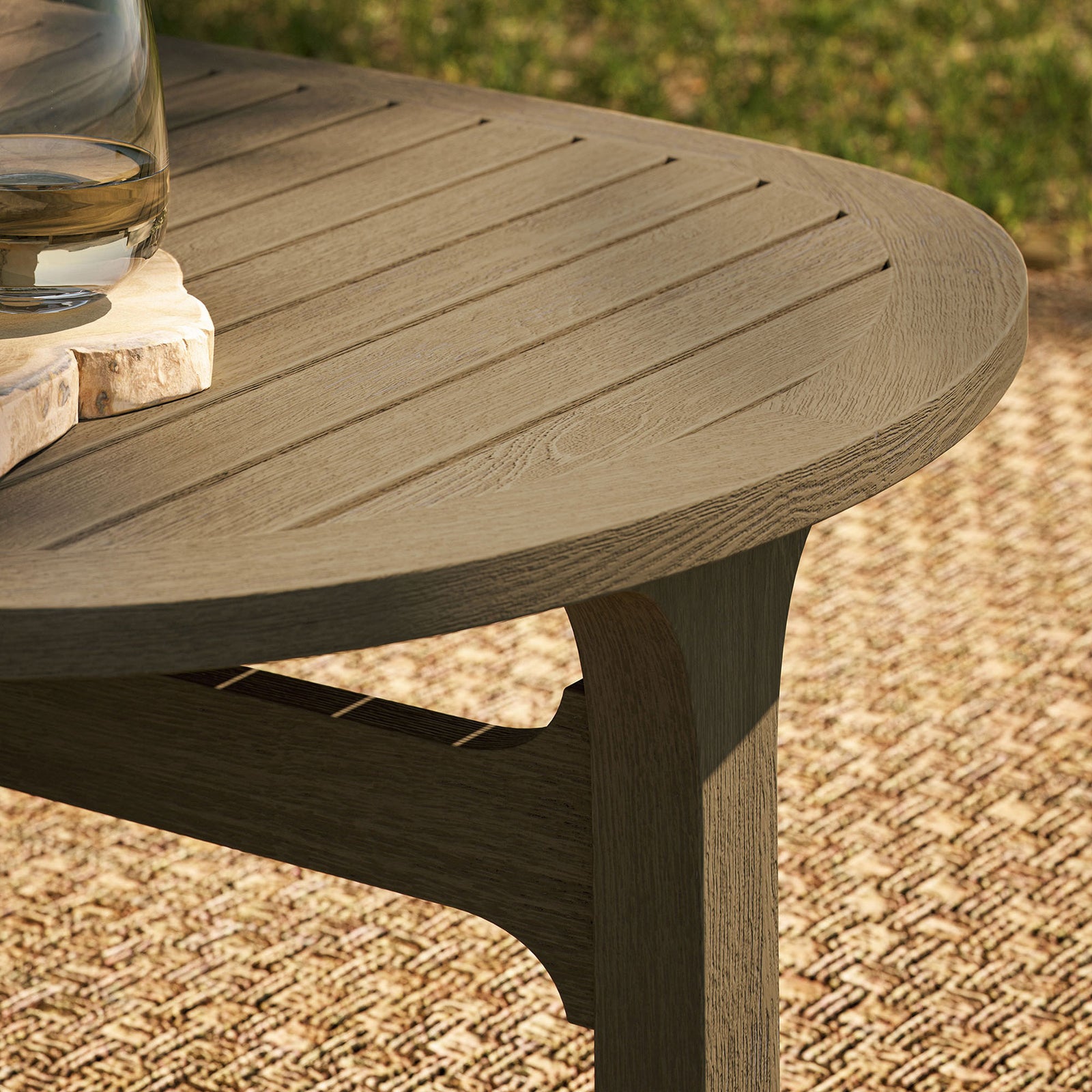 Detail of the weathered gray teak slatted tabletop styled with outdoor drinks on a woven rug || EEI-7246-WGR || detail_room