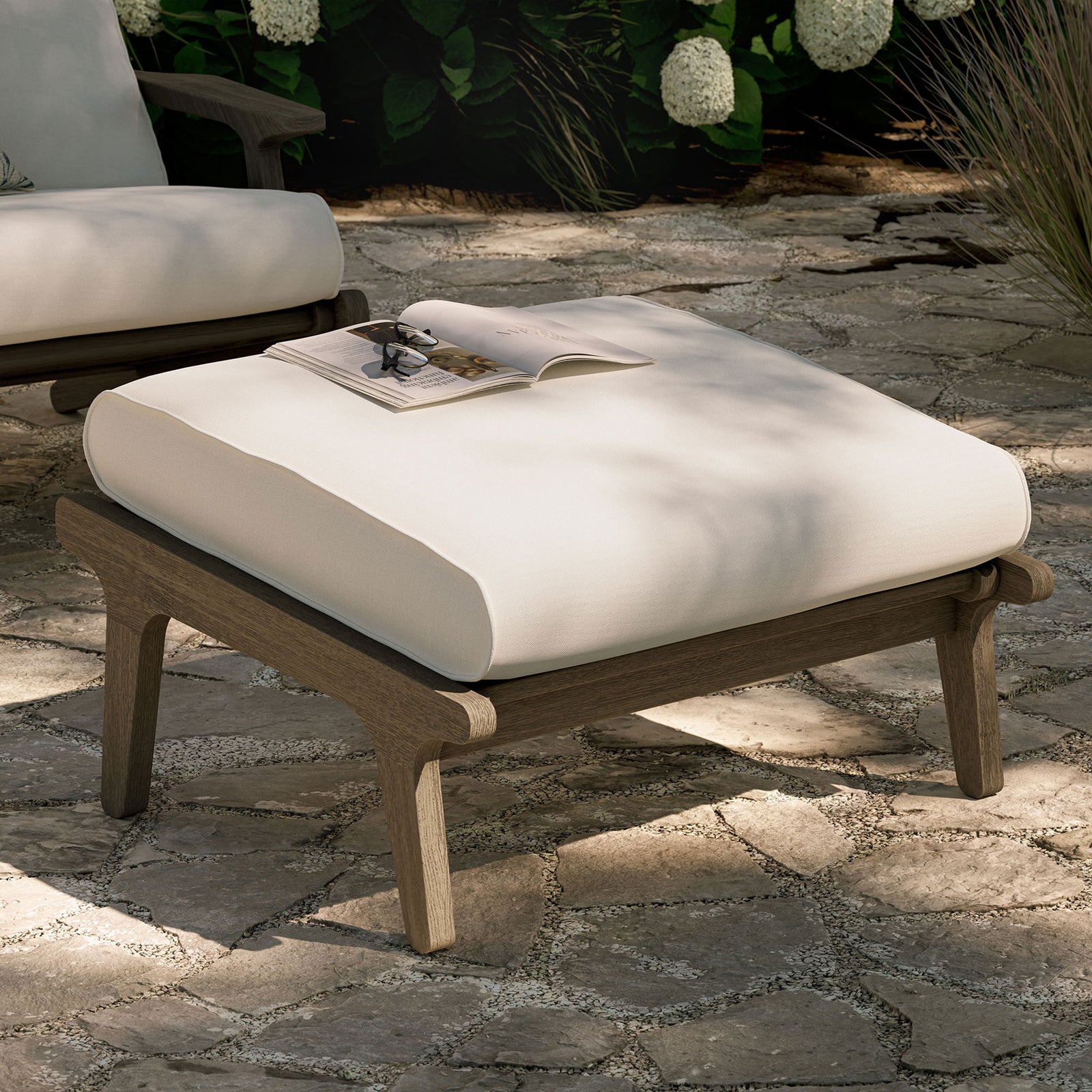 White cushioned teak ottoman arranged outdoors as a chic footrest and inviting extra patio seat || EEI-7250-WGR-WHI || front_angle_room