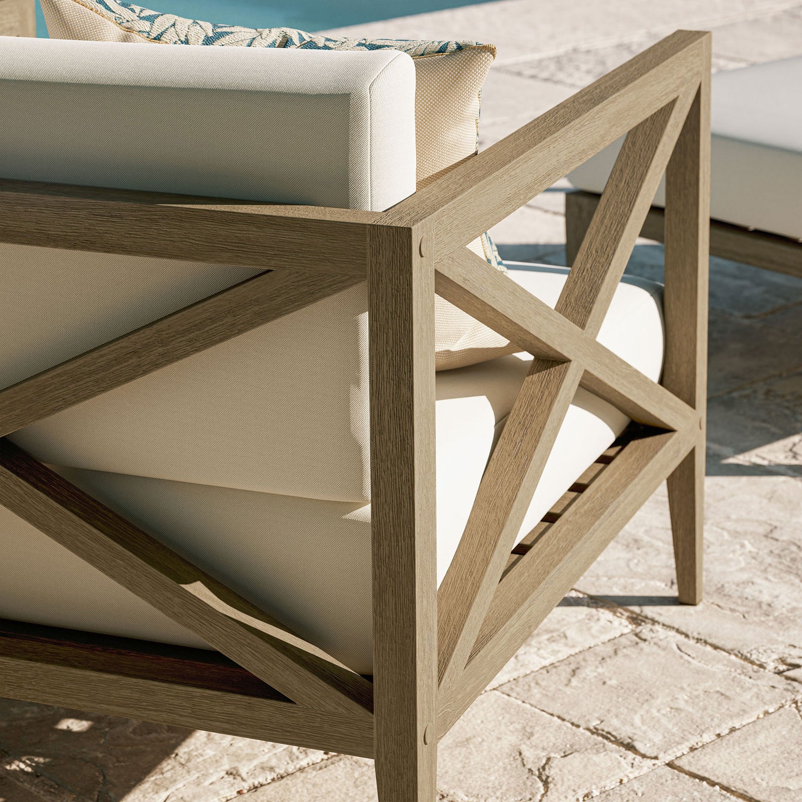 Sunlit teak frame and white cushions shown in an outdoor setting, emphasizing relaxed comfort and style || EEI-7252-WGR-WHI || detail_room