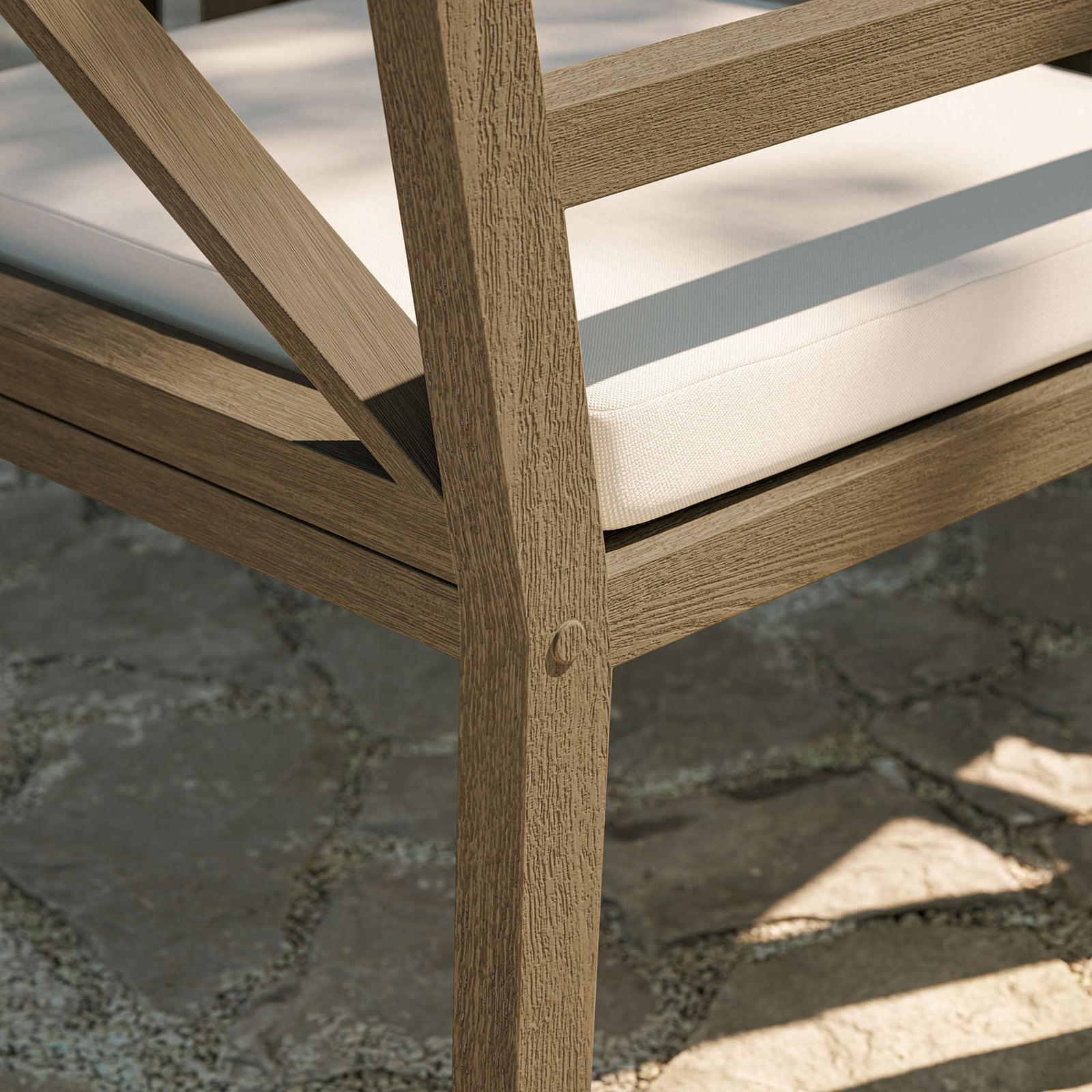 Weathered teak frame and white cushion framed by stone pavers evoke a relaxed coastal retreat. || EEI-7253-WGR-WHI || leg_room