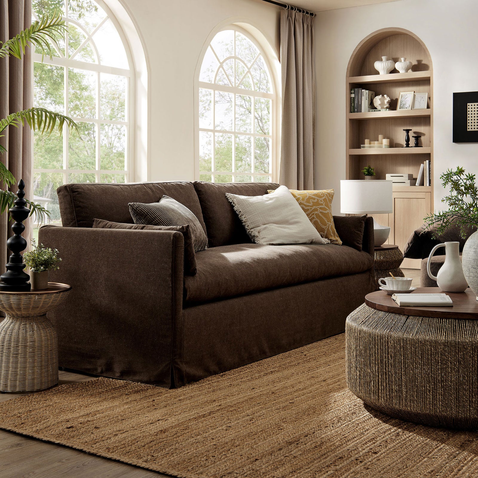Cocoa slipcovered sofa anchors an airy living room, paired with a woven coffee table and natural jute rug. || EEI-7260-COA || front_angle_room