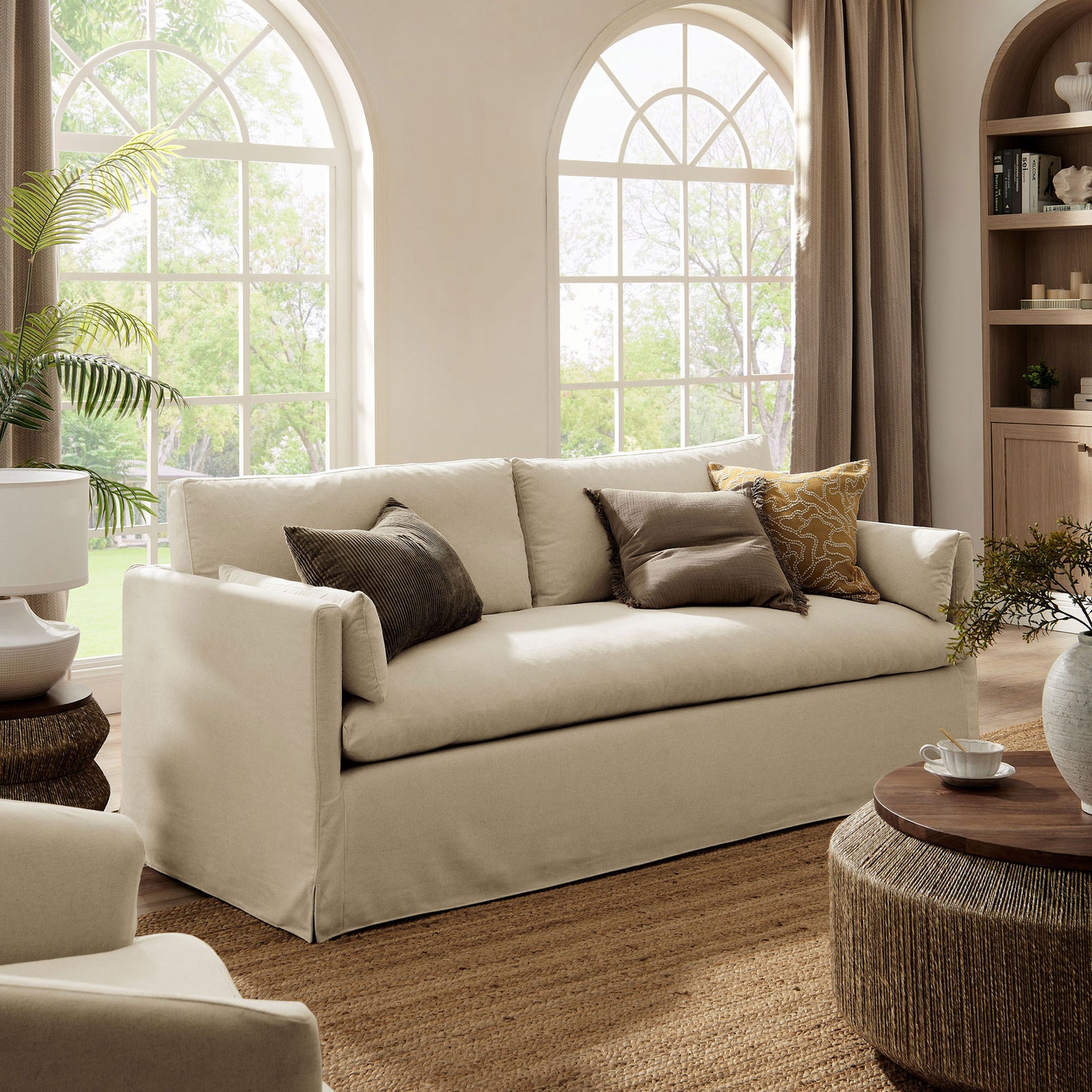 Wellfleet linen sofa paired with woven tables and rug for a relaxed, modern coastal look || EEI-7260-LIN || front_angle_room