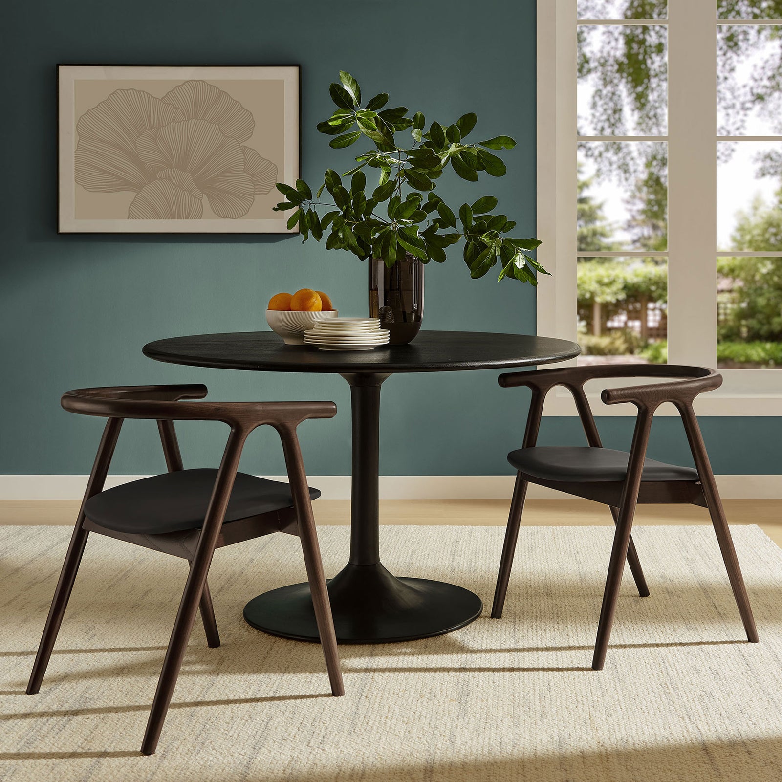 Pair of Henry dining chairs with round pedestal table creating a modern, inviting dining nook || EEI-7291-BLK || front_angle_room