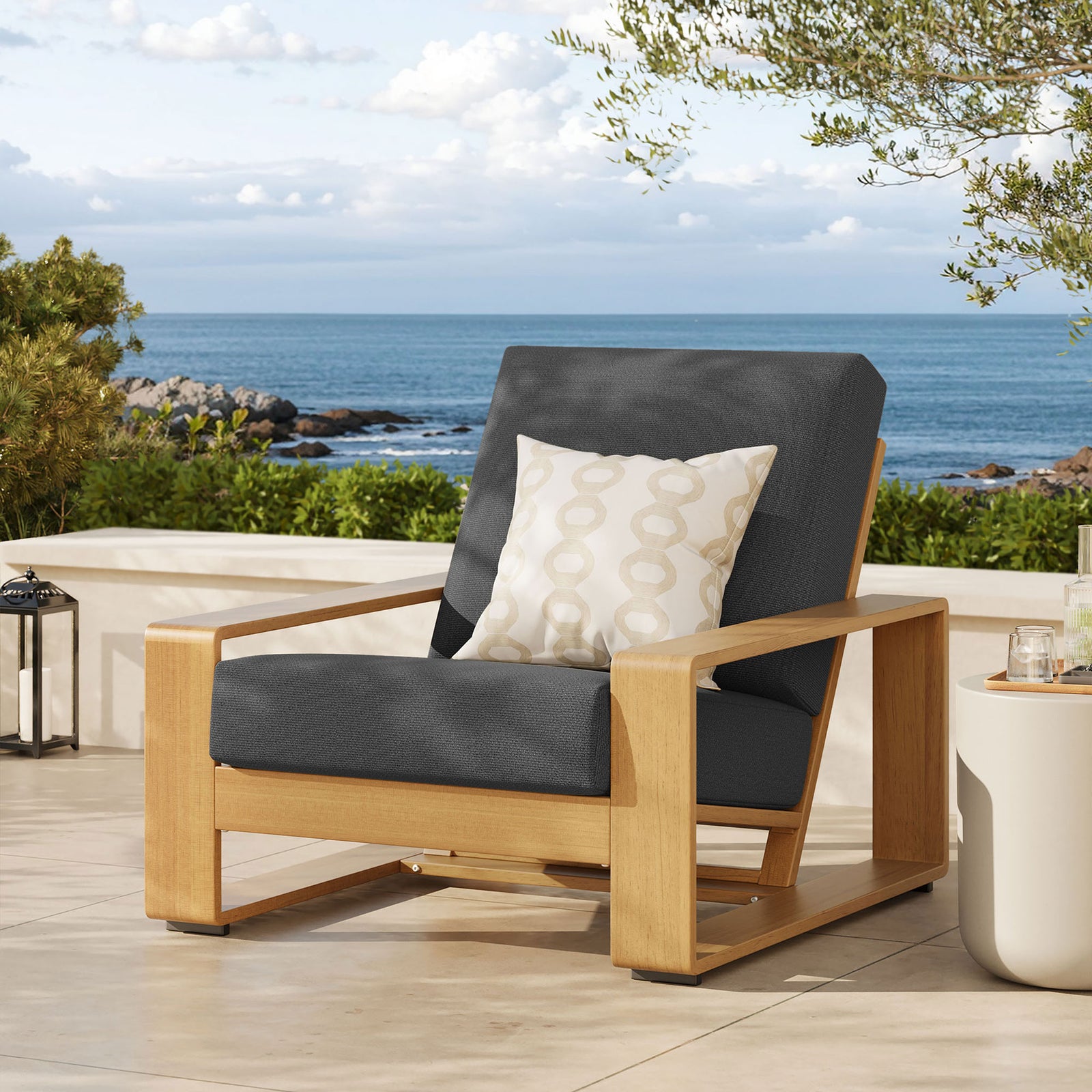 Charcoal and natural faux wood armchair creating a cozy focal point on a sunlit coastal patio || EEI-7296-CHA-NAT || front_angle_room