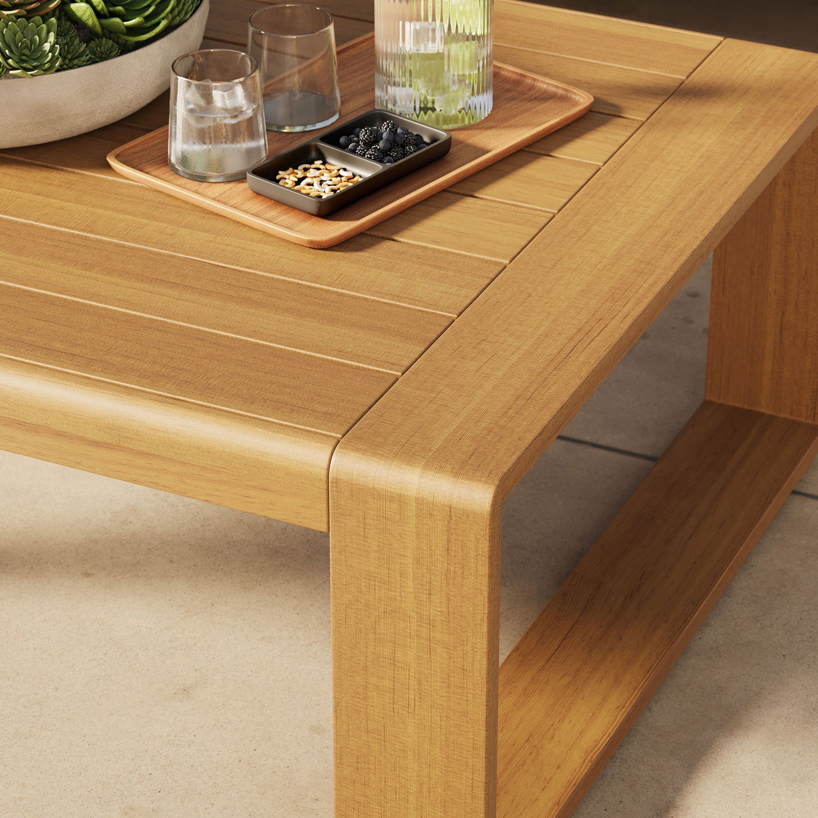 Natural faux wood outdoor coffee table styled with drinks and decor on a sunny patio || EEI-7299-NAT || detail_room