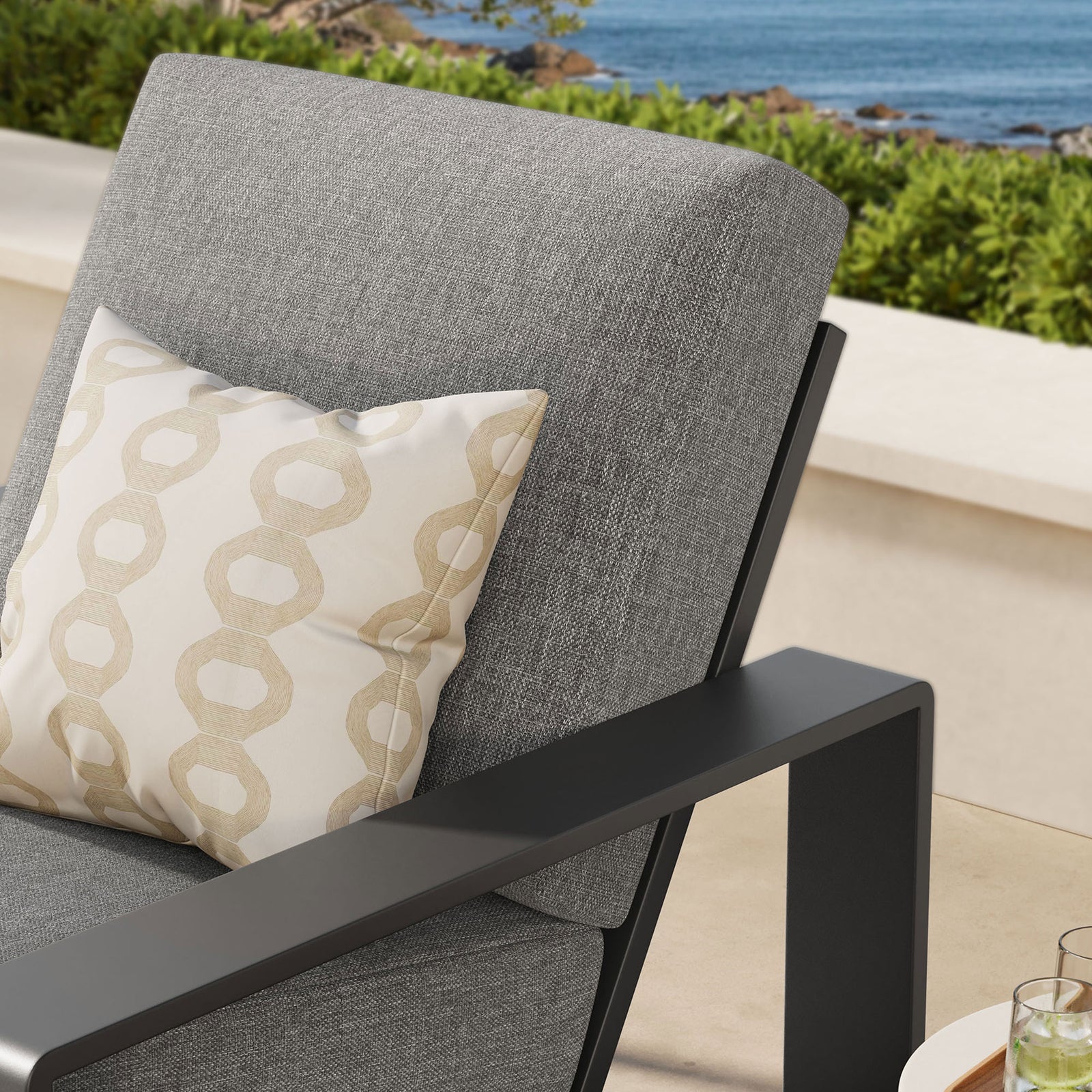 Light gray cushion and charcoal arm detail bring soft contrast to an inviting outdoor retreat || EEI-7300-LGR-GRY || detail_room