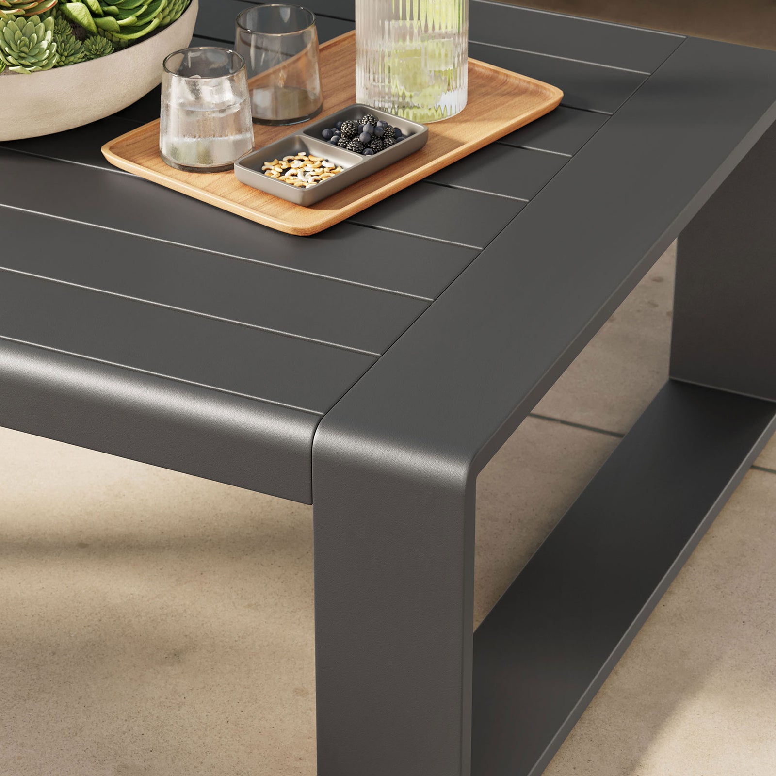 Gray outdoor coffee table styled with drinks and decor on a sunny patio || EEI-7303-GRY || detail_room