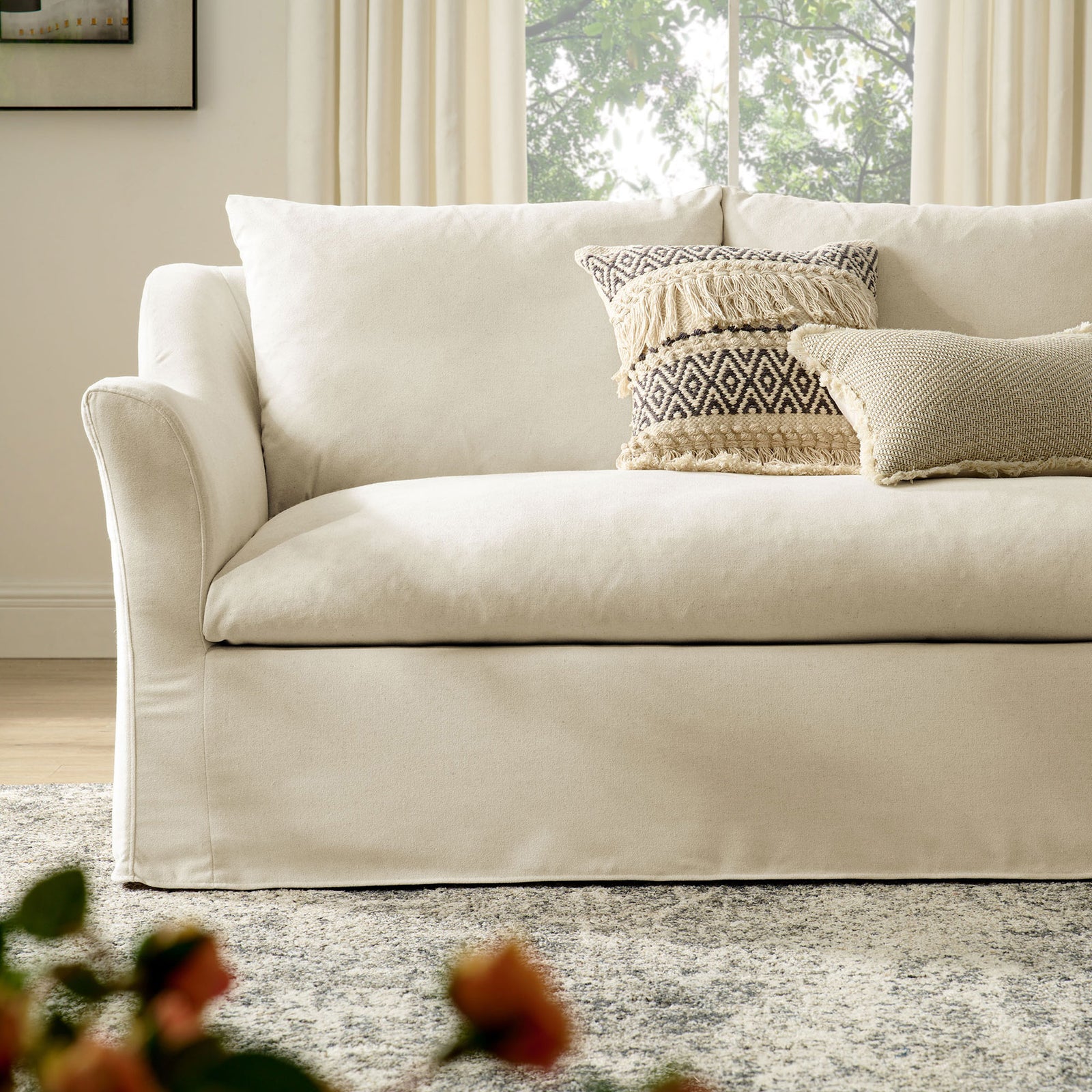 Somerset sofa styled in a bright living room with layered neutral pillows and relaxed slipcovered silhouette || EEI-7310-LIN || detail_room