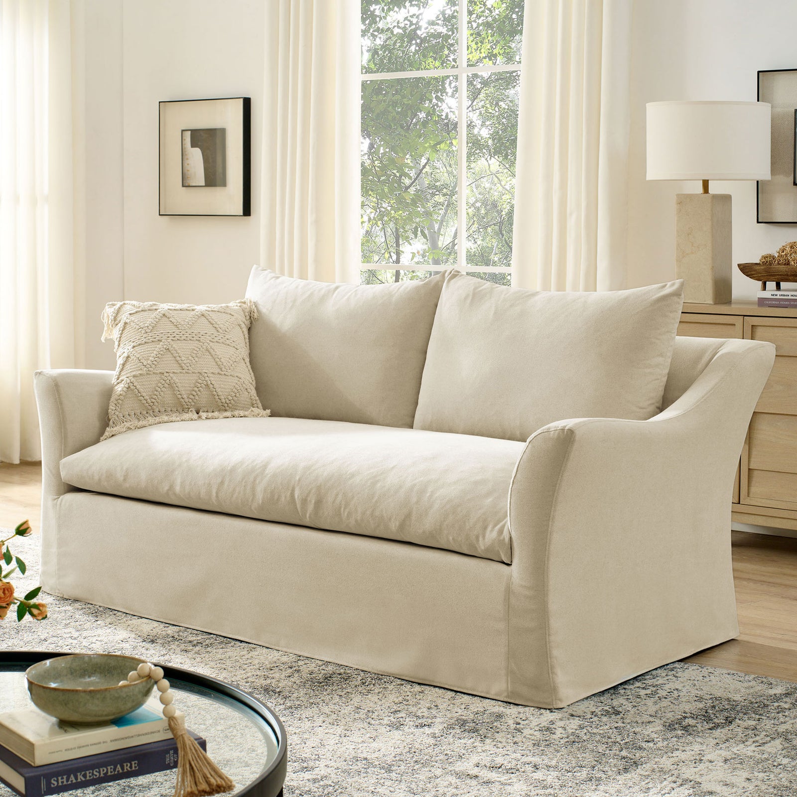 Linen slipcovered loveseat styled with rug, accent pillow, and light wood furniture || EEI-7311-LIN || front_angle_room
