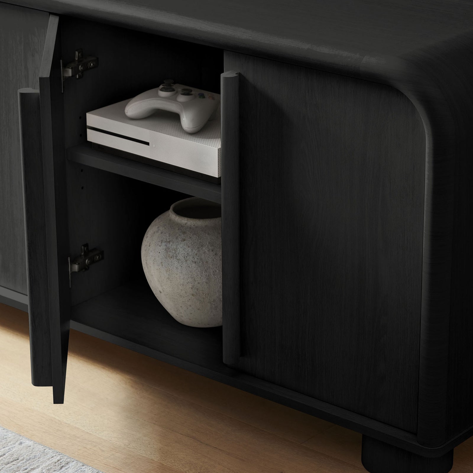 Open cabinet storage displaying an entertainment console and vase inside the Bellamy black oak sideboard || EEI-7315-BLK || storage_open_room