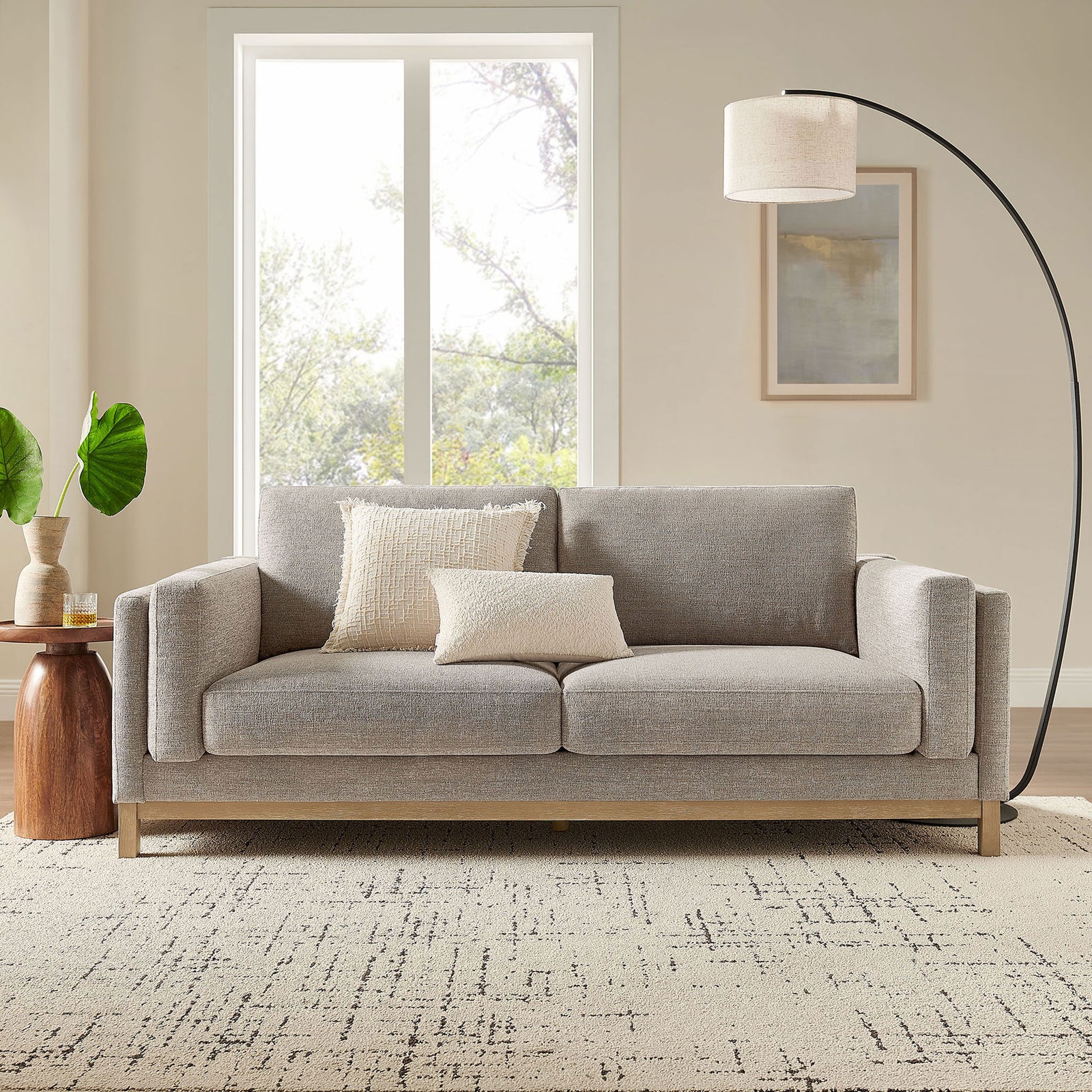 Roscoe pewter sofa styled in a modern living room with layered pillows, floor lamp, and wood accents || EEI-7327-PEW || front_room