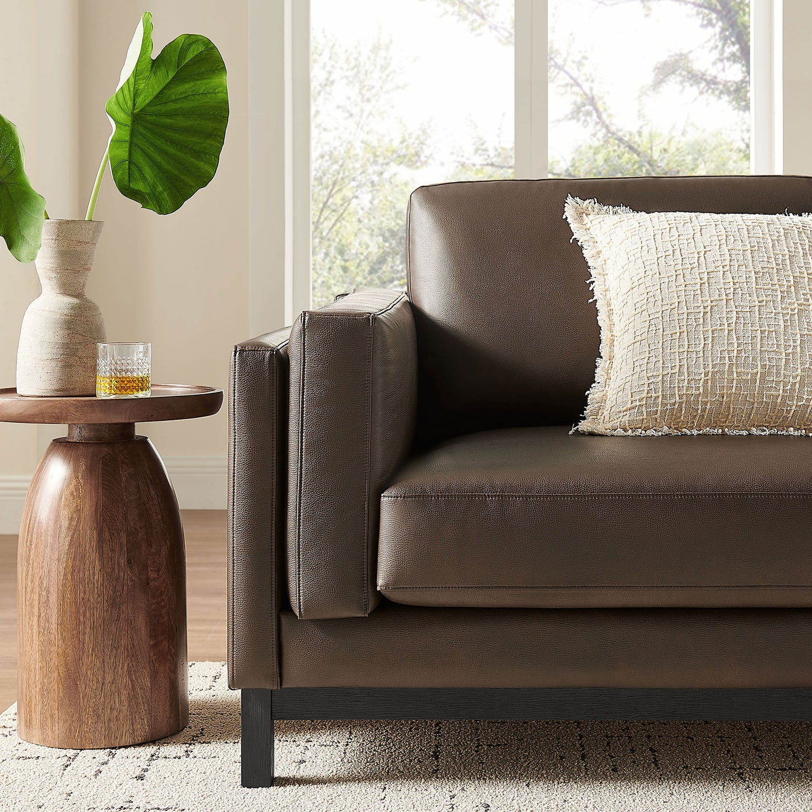 Styled corner of the Roscoe sofa in a bright living room with accent table and textured pillow || EEI-7335-ESP || detail_room