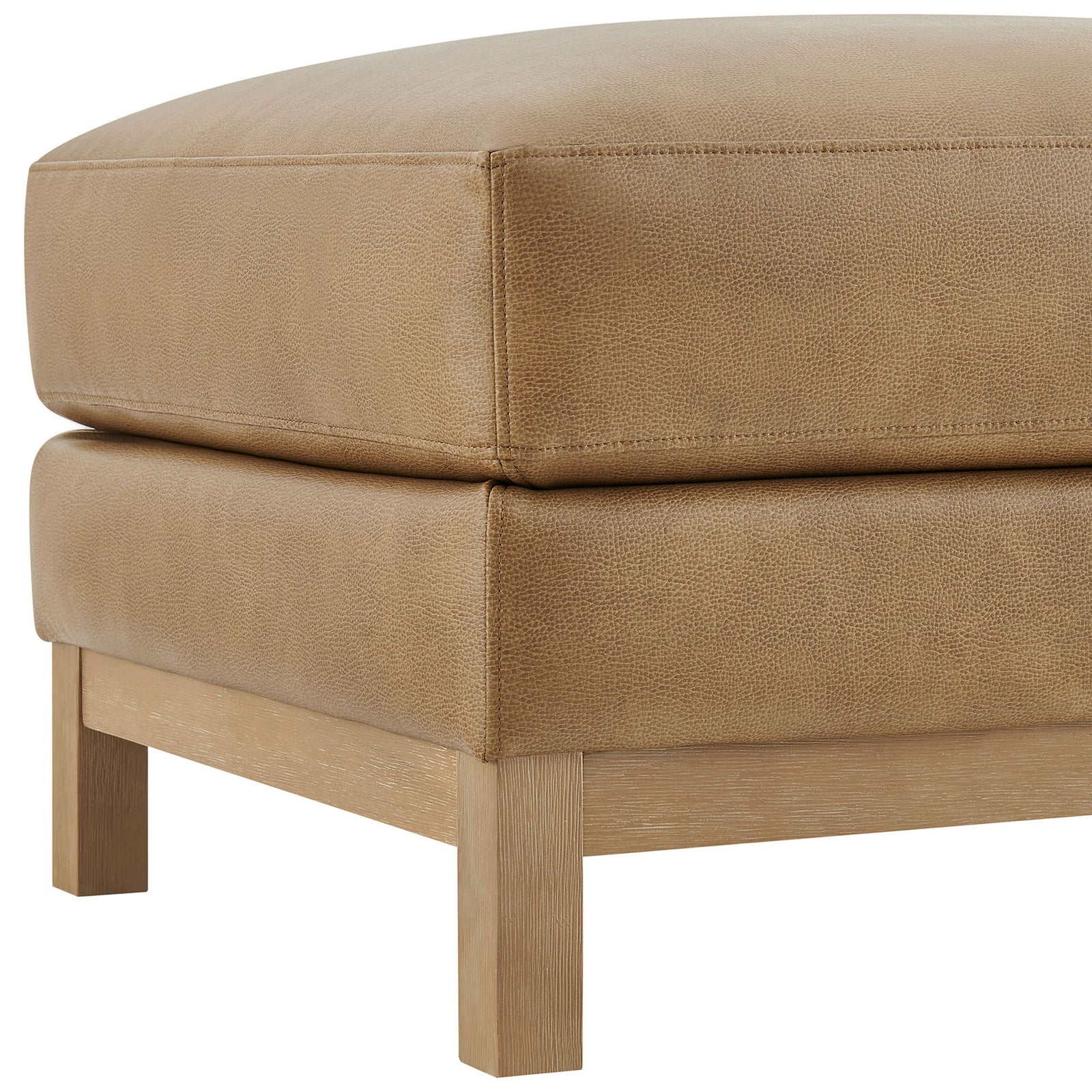 Stitched vegan leather upholstery and solid wood leg showcase the ottoman's refined craftsmanship || EEI-7338-TST || detail_studio