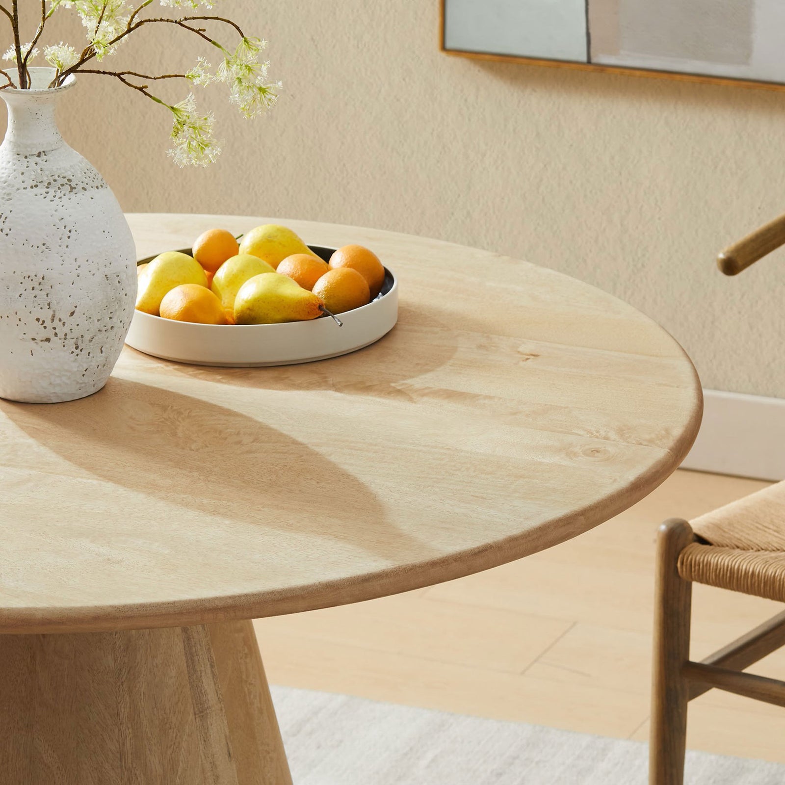 Styled tabletop with fruit bowl and ceramic vase to showcase the table's warm natural wood finish. || EEI-7343-NAT || detail_room
