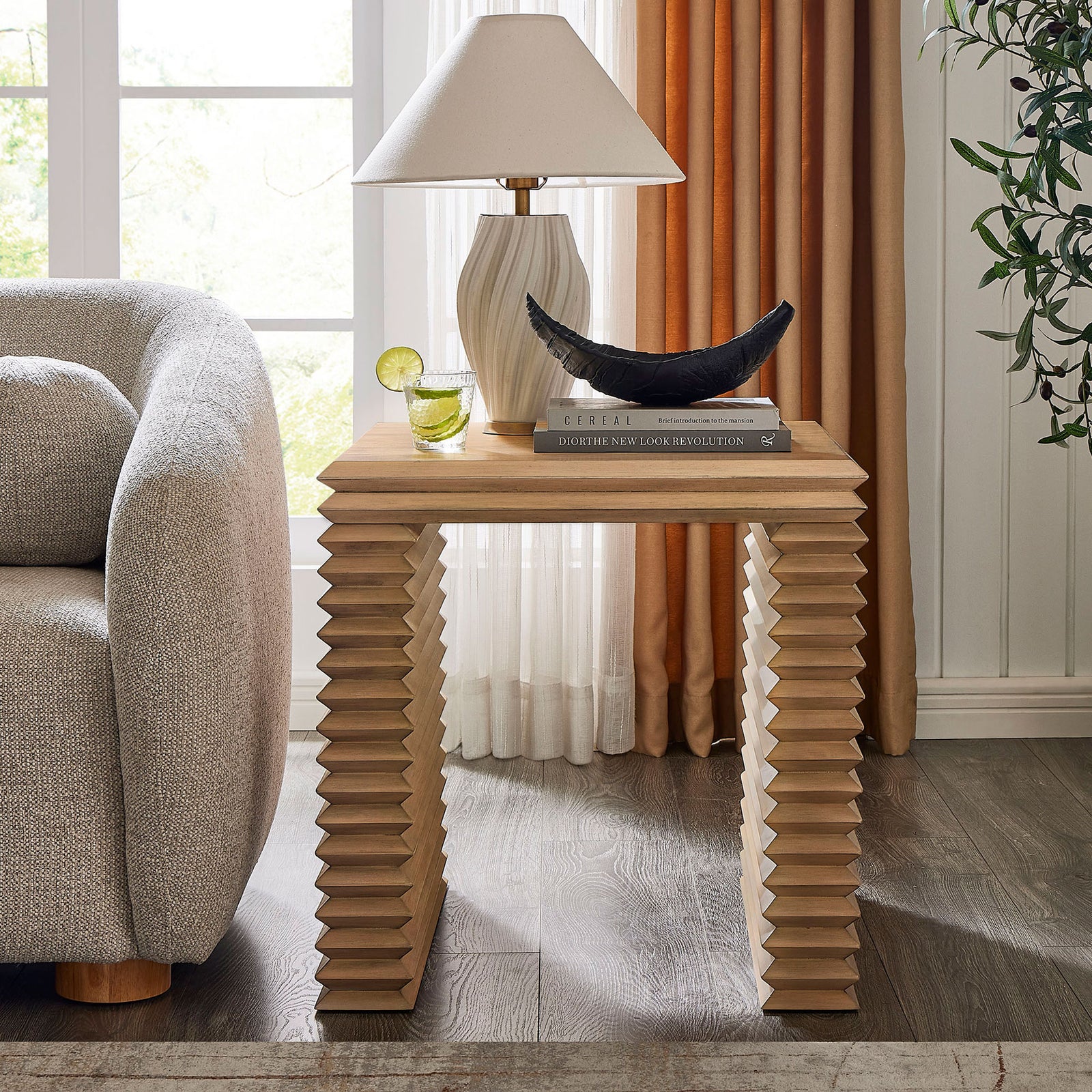 End table anchors a cozy living room vignette with its sculptural stacked legs and spacious oak tabletop || EEI-7349-WOA || front_angle_room