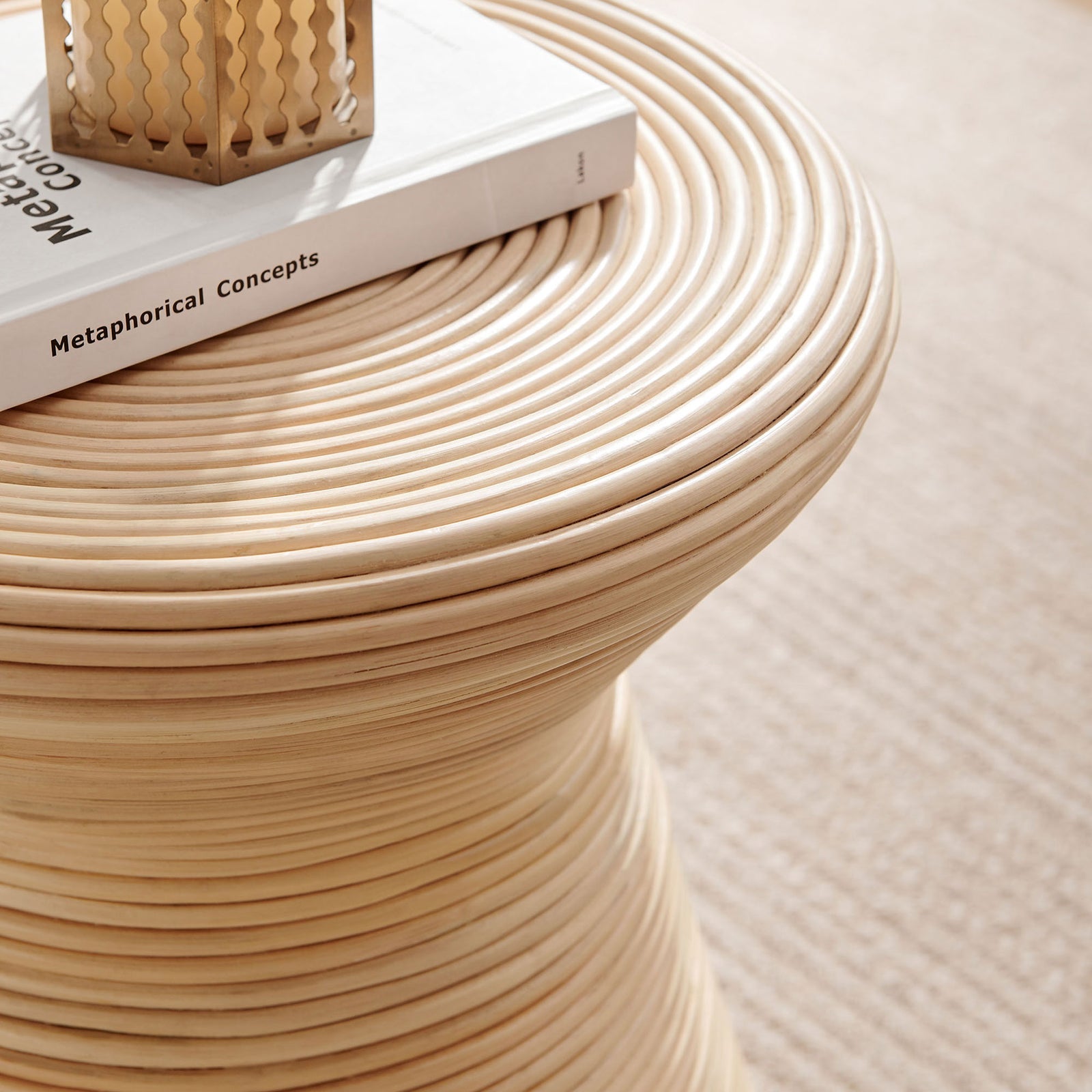 Natural rattan side table styled with a book and candle, bringing layered texture to a light-filled room || EEI-7360-NAT || detail_room
