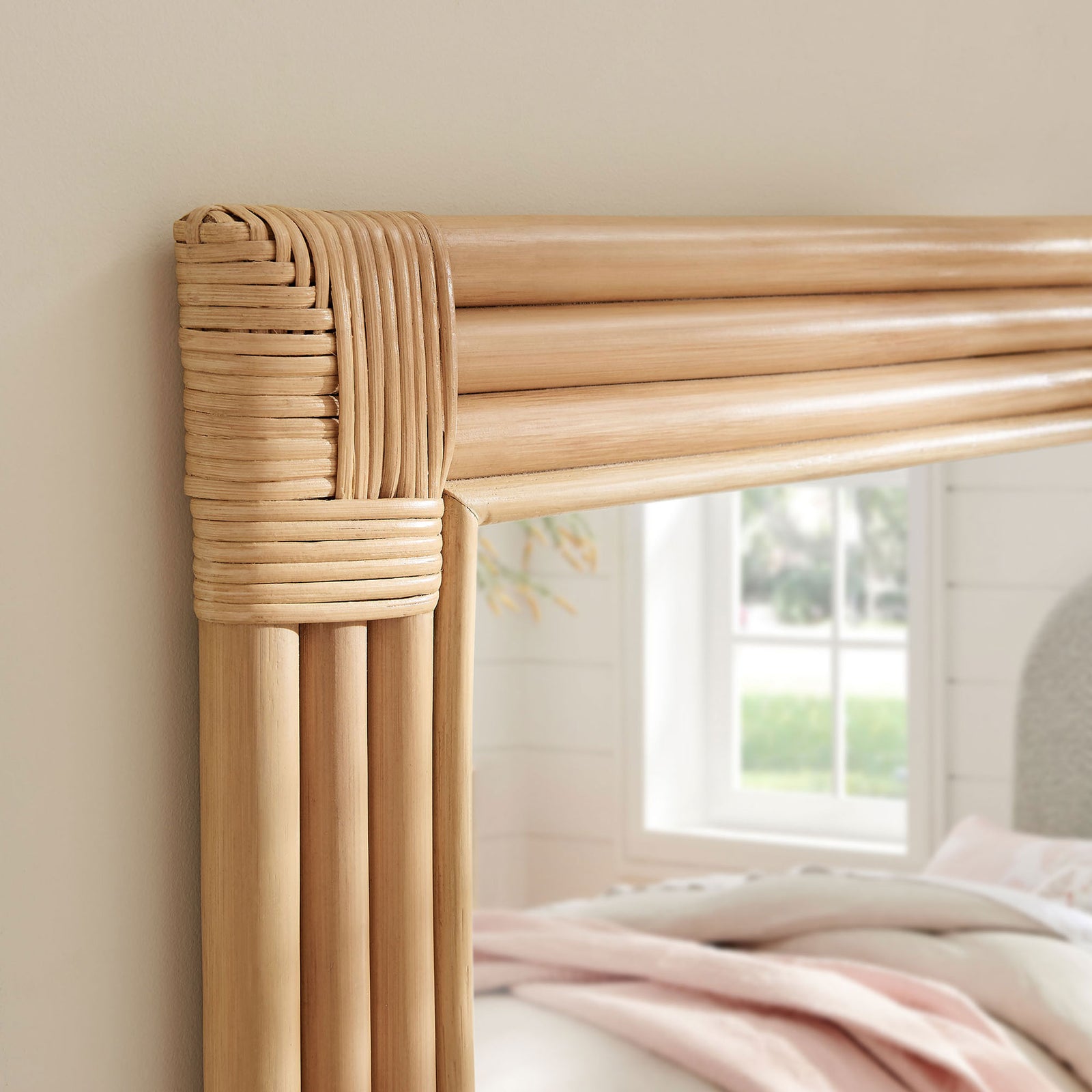 Corsica rattan mirror corner bringing warm texture beside a sunlit window and cozy bed || EEI-7368-NAT || detail_room