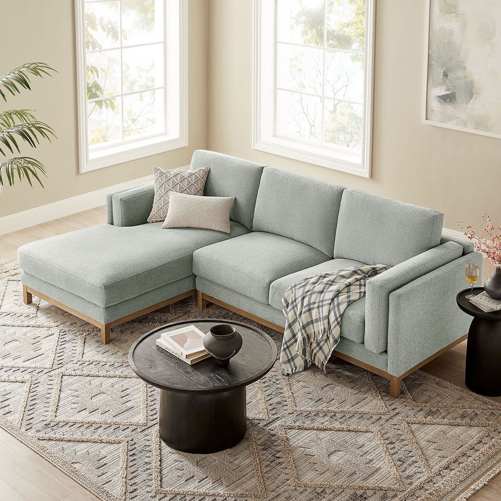 Mist fabric sectional sofa with chaise paired with a black drum coffee table and patterned rug || EEI-7374-MST || front_angle_room
