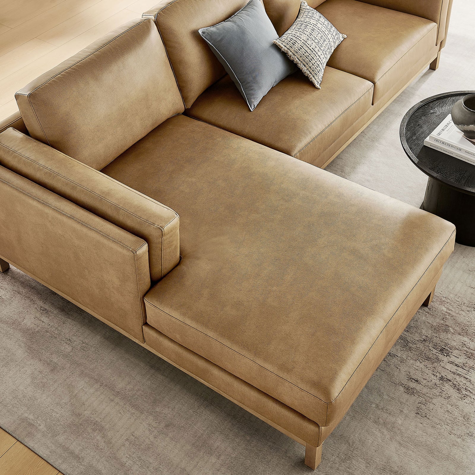 Left-facing chaise in smooth toast vegan leather with softly textured finish and accent pillows || EEI-7376-TST || detail_room