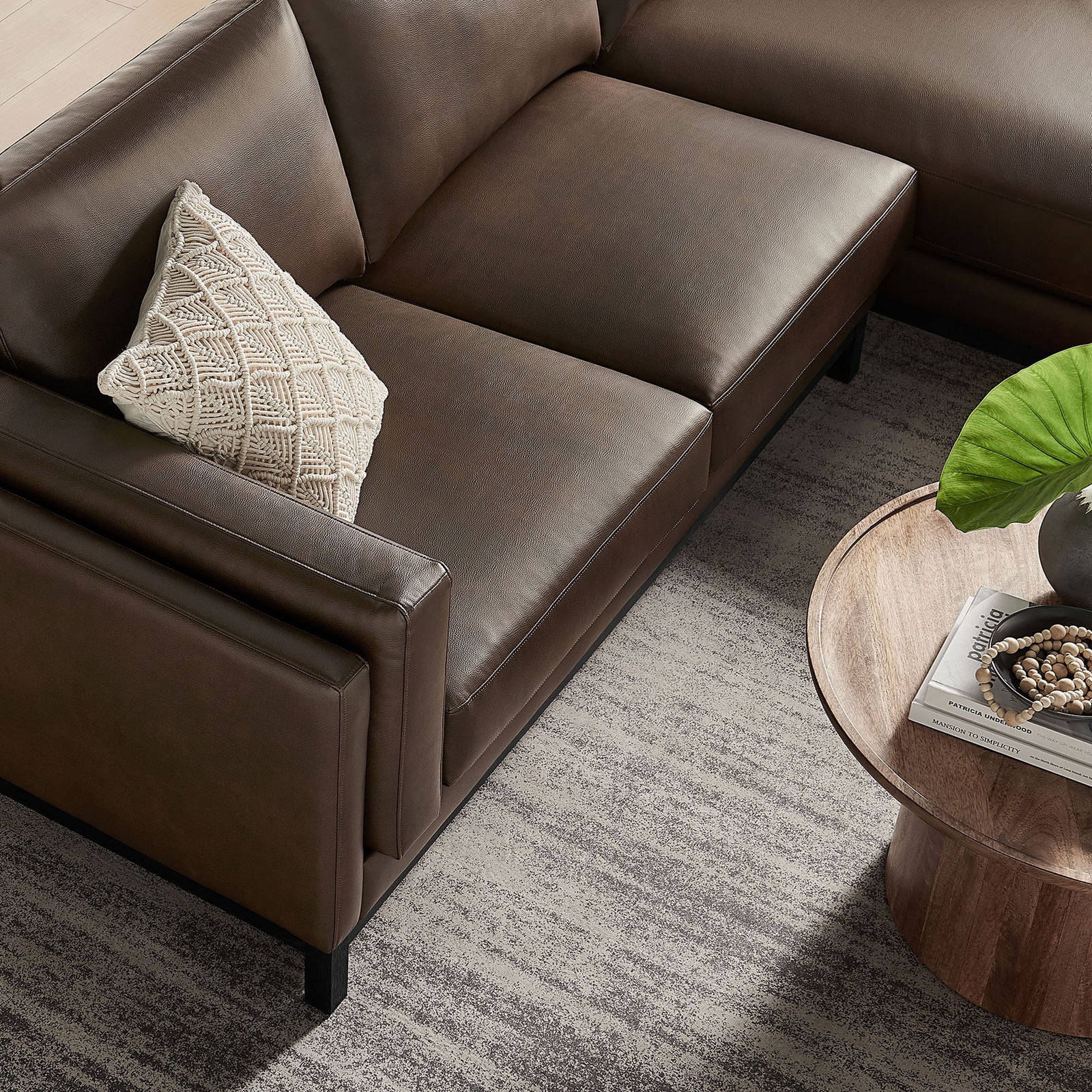Seat and arm detail of the Roscoe right-facing espresso sectional with textured accent pillow || EEI-7377-ESP || detail_room