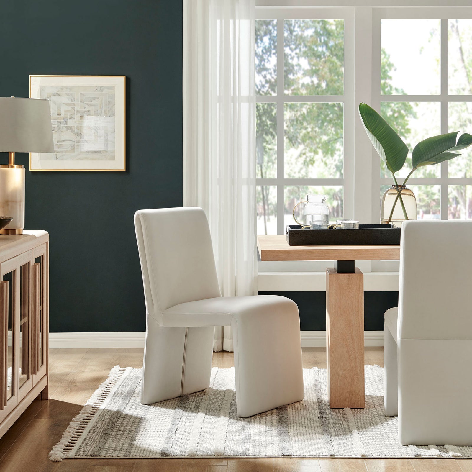 Pair of alabaster velvet Emory dining chairs bring cozy modern style to a bright dining room with wood table || EEI-7384-ALA || front_angle_room