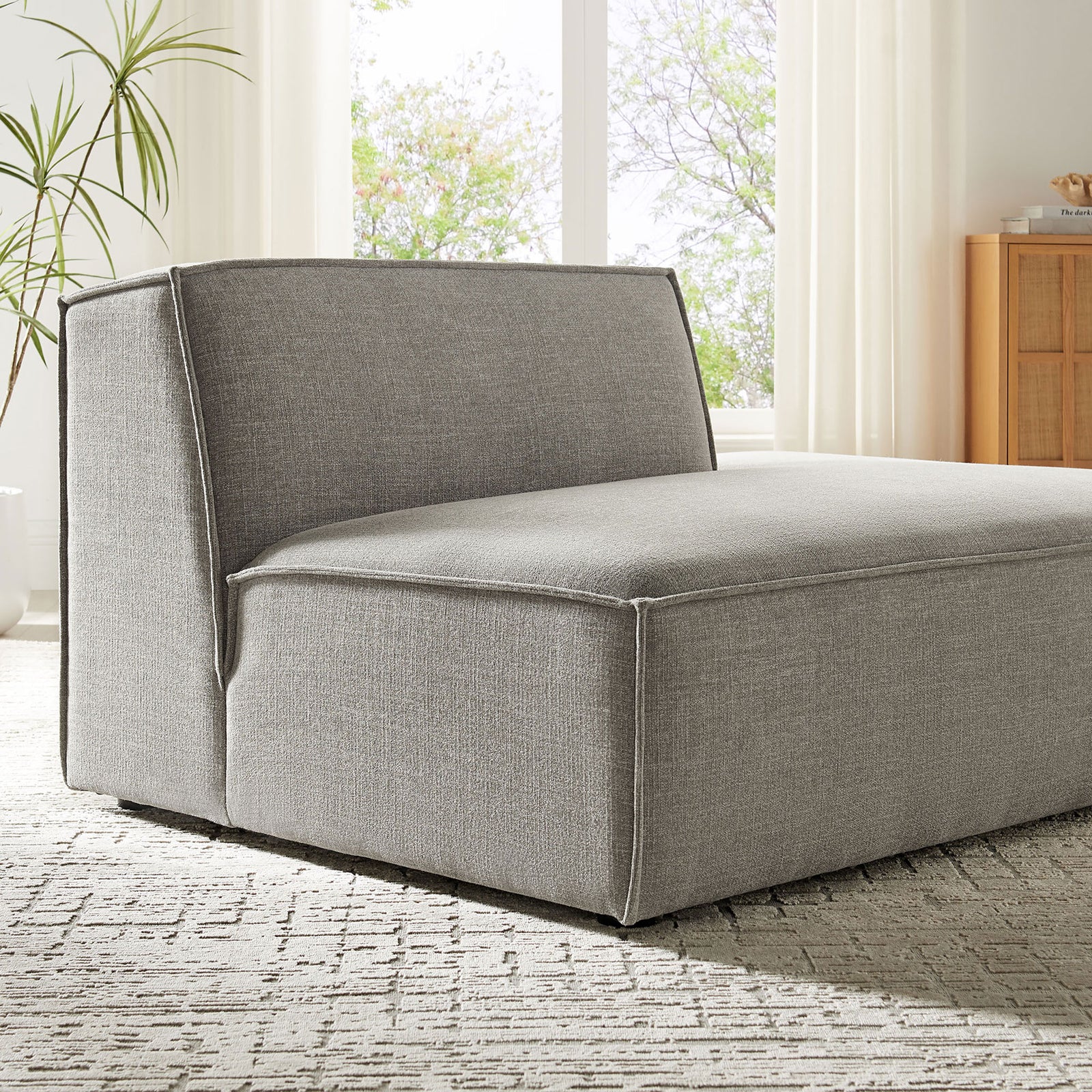 Soft gray upholstery and tailored piping bring understated texture to modern decor || EEI-7388-PEW || detail_room