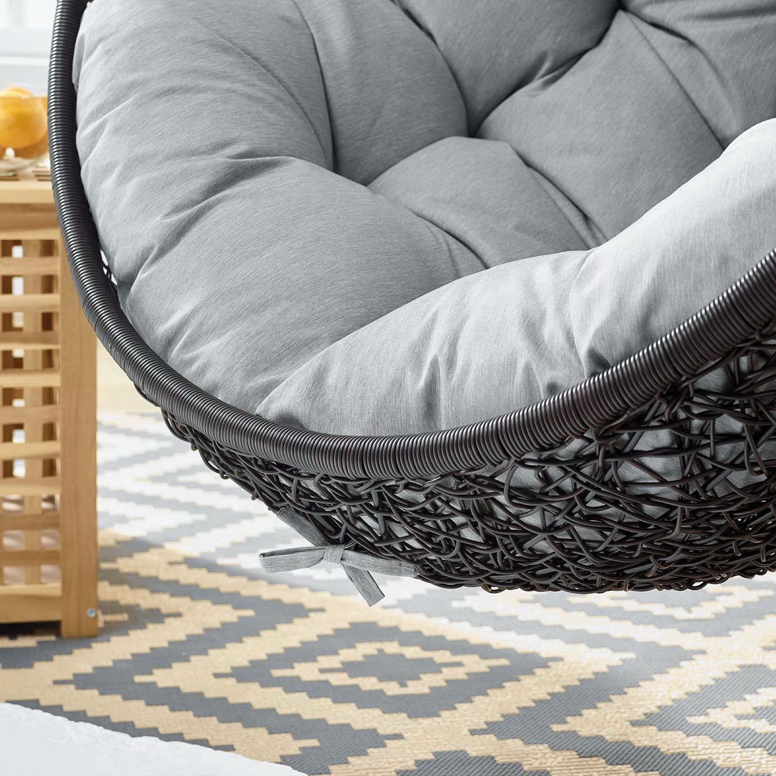 Soft gray cushion rests above a patterned outdoor rug, emphasizing comfort and casual style || EEI-739-GRY-SET || swatch_room