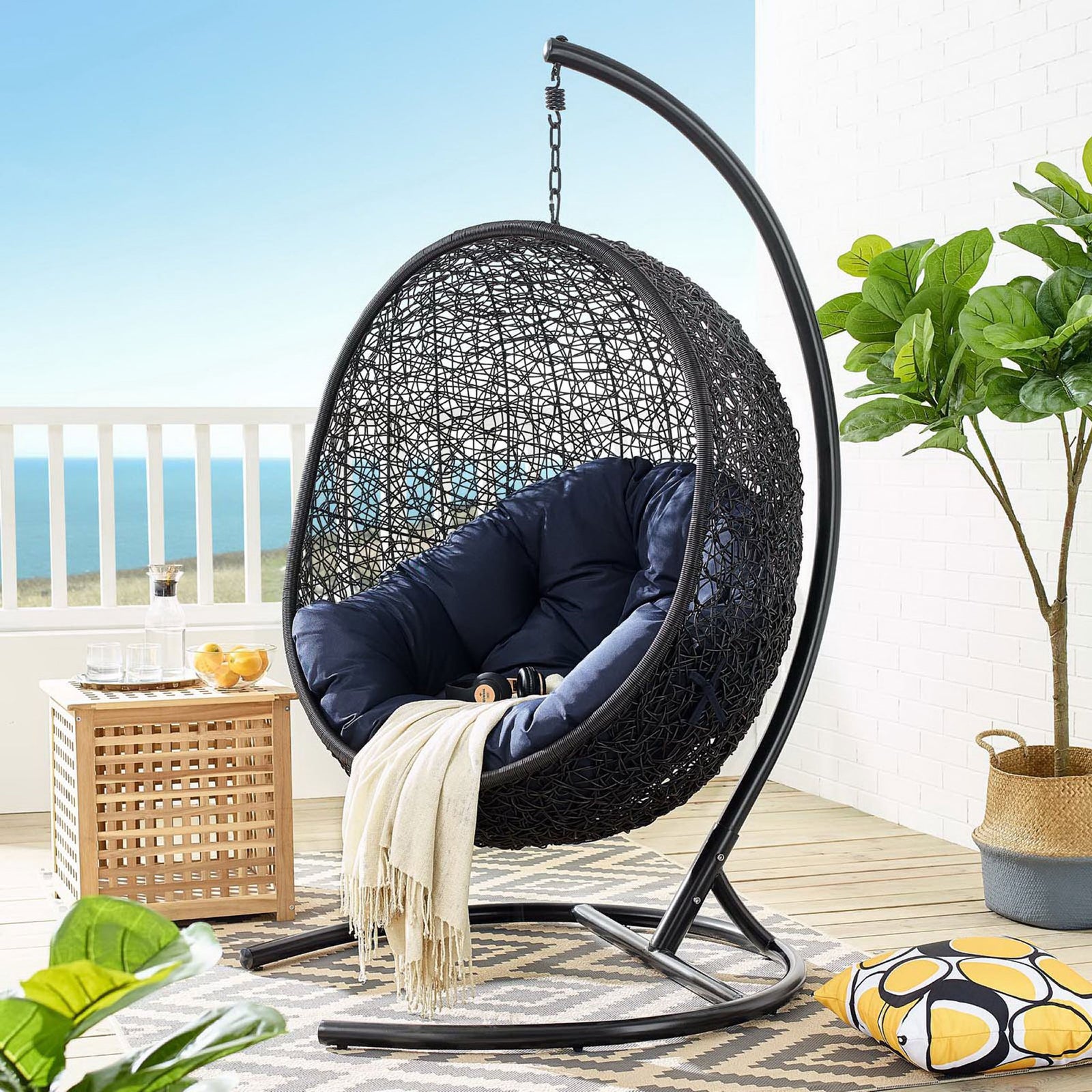 Navy cushioned egg chair with stand creates a dramatic statement piece on the oceanfront patio || EEI-739-NAV-SET || front_angle_room