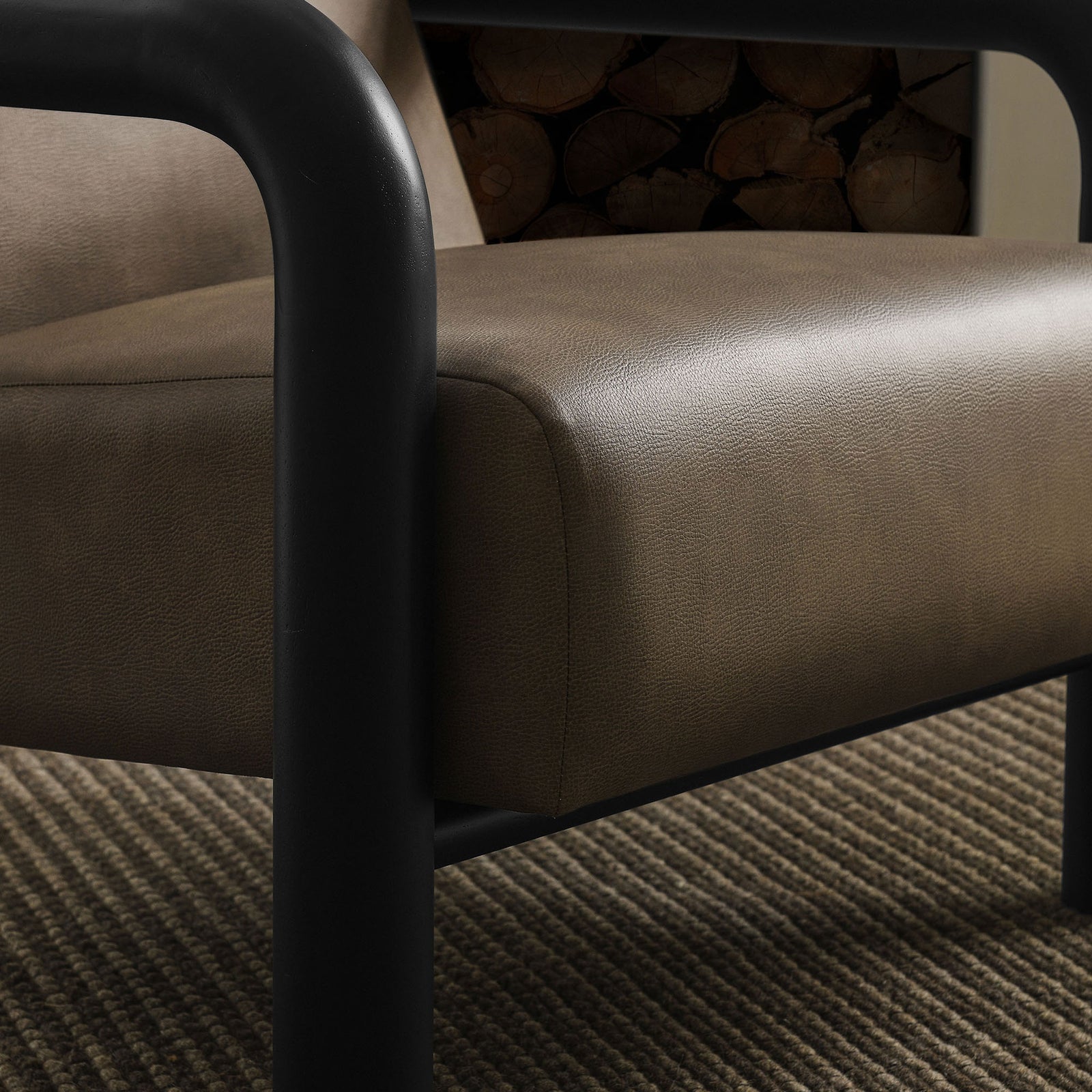 Soft, pebbled upholstery and supportive cushioning invite lingering in any modern space. || EEI-7392-MUS-BLK || detail_room